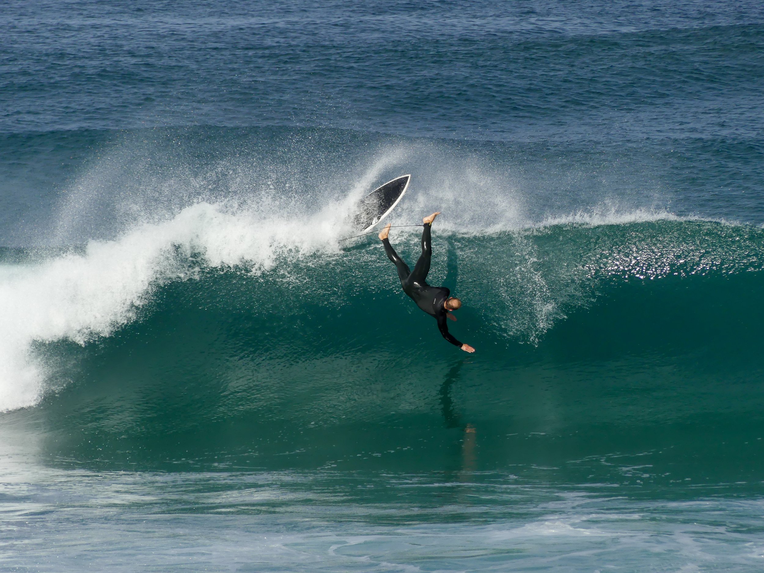 Surfer falling into a wave at South beach, Wollongong