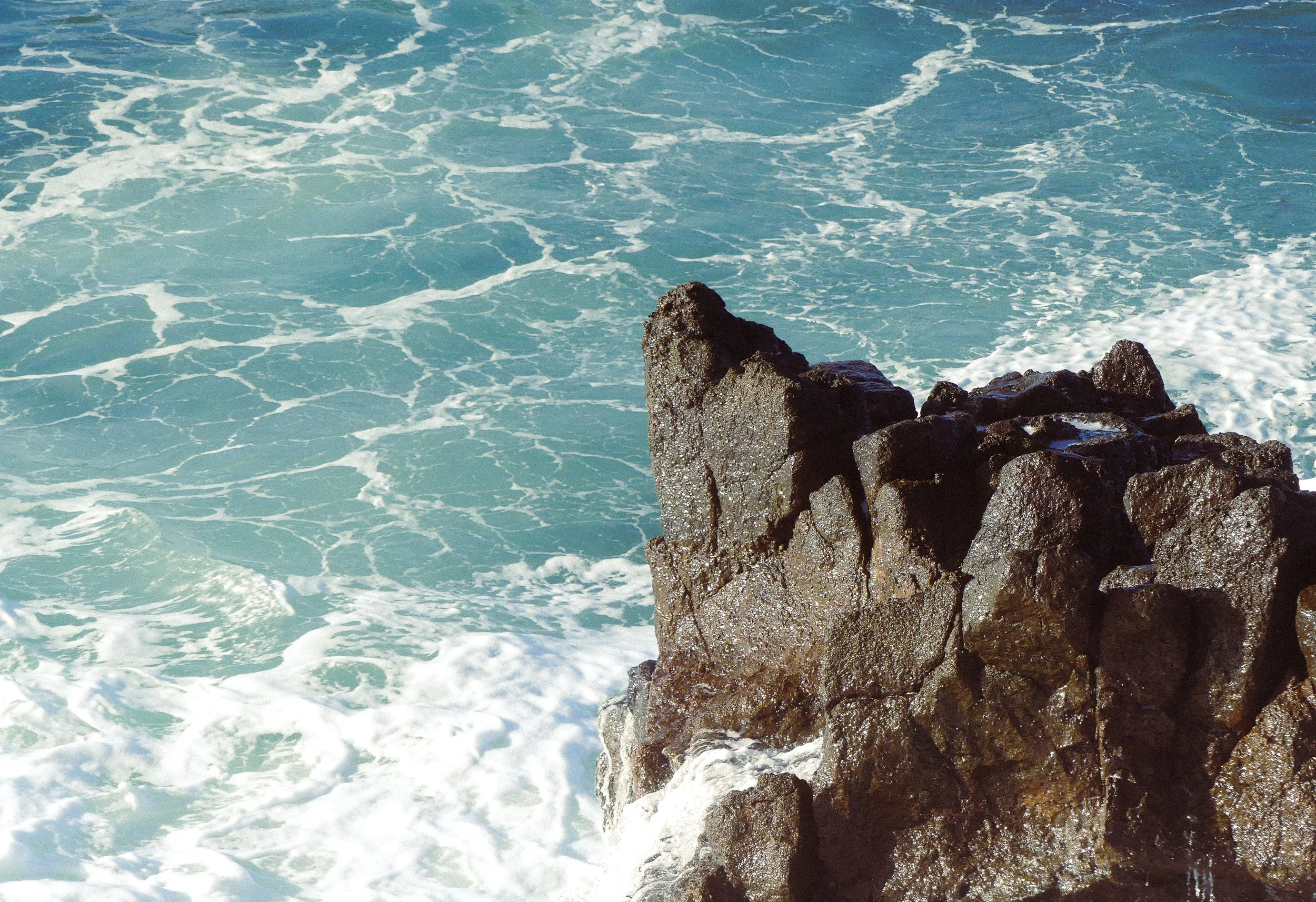 Drenched rocks amongst ocean whitewash at Port Kembla, Wollongong