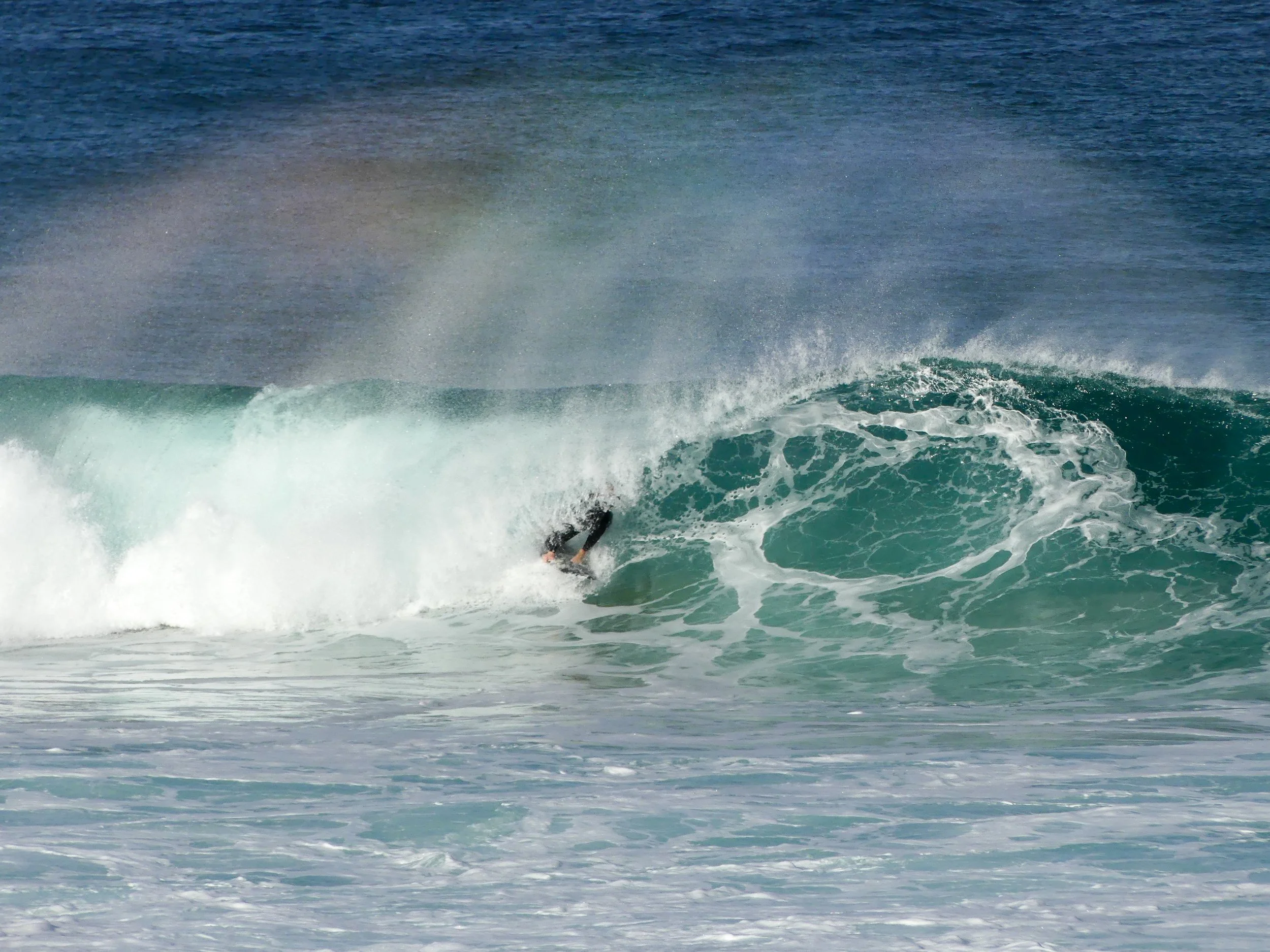 Surfer caught in a rainbow barrel at South beach, Wollongong