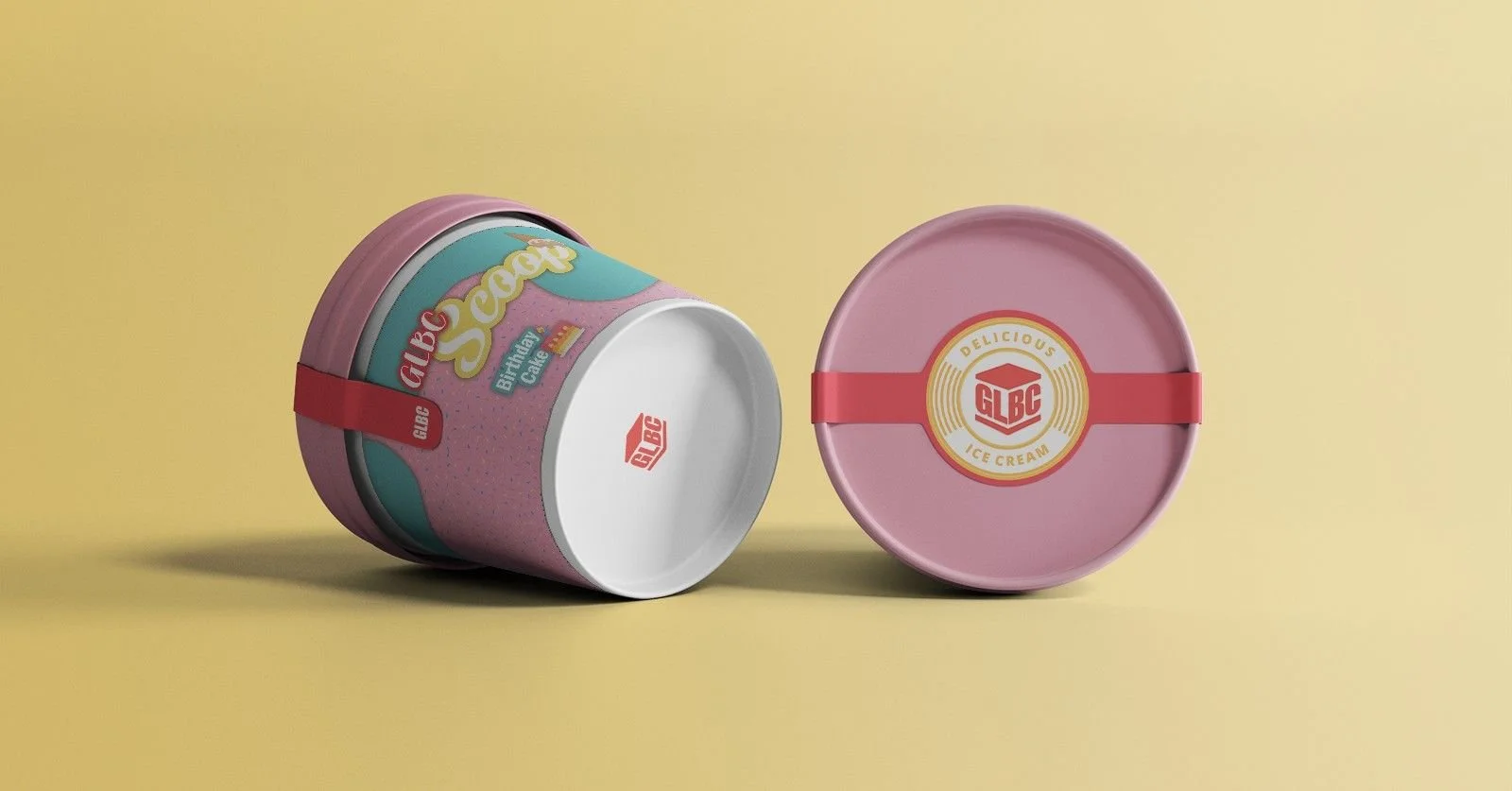 Pink and teal ice cream container with a red strap, labeled 'GLBC Delicious Ice Cream,' on a yellow background, with the lid removed showing the inside of the container.