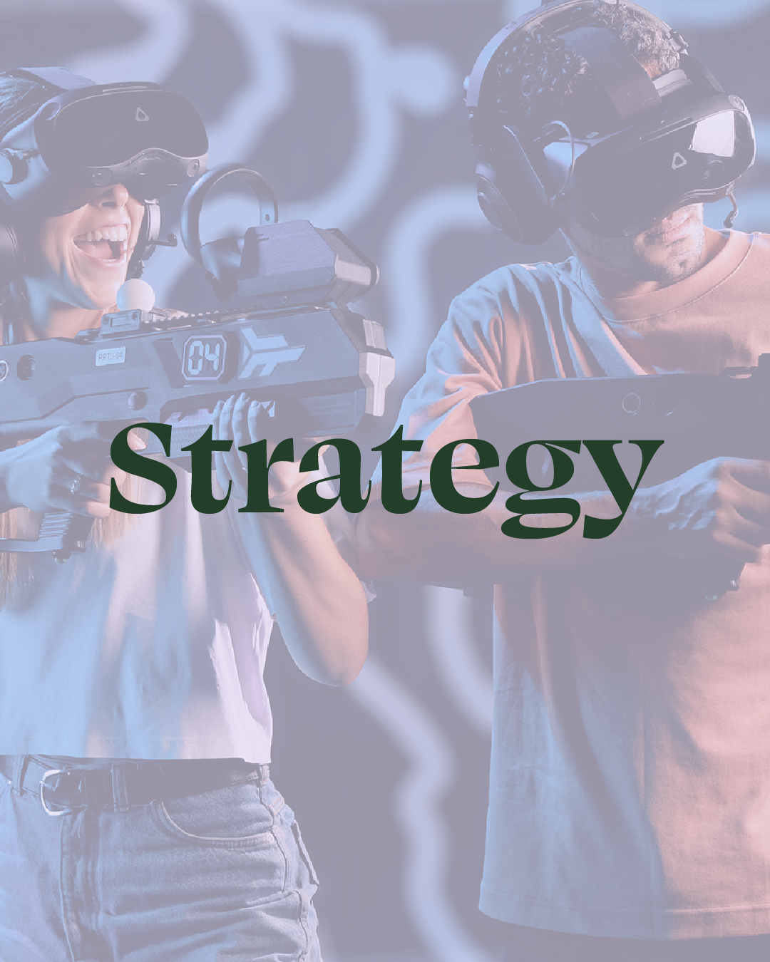 Two people wearing virtual reality headsets, one woman and one man, engaging with VR devices. The woman is smiling and holding a gaming controller, while the man is focused on a different VR controller. The word 'Strategy' is overlaid on the image.