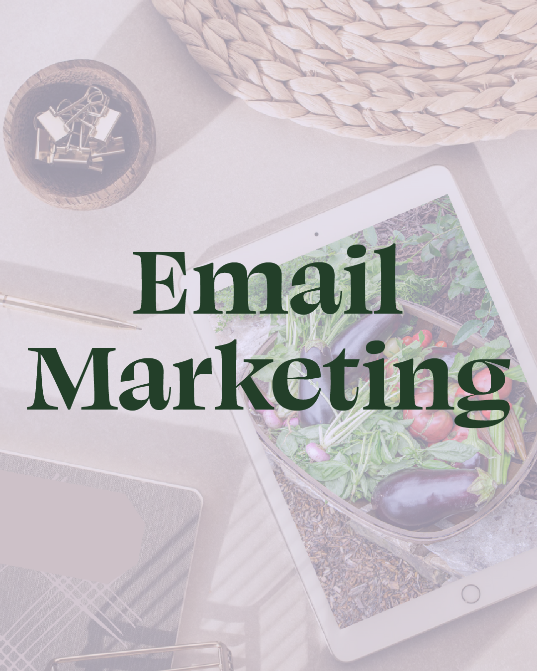 Digital tablet displaying a garden scene with vegetables, on a desk with a woven basket, a small bowl of paper clips, a notepad, and a pen.