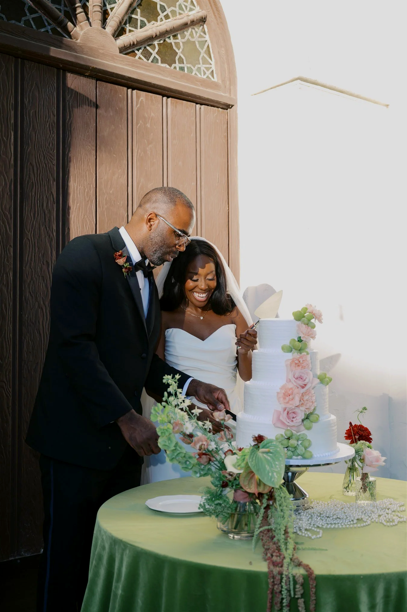 Happy couple cutting wedding cake during reception. Full-service wedding planning and coordination by Santa Barbara wedding planners