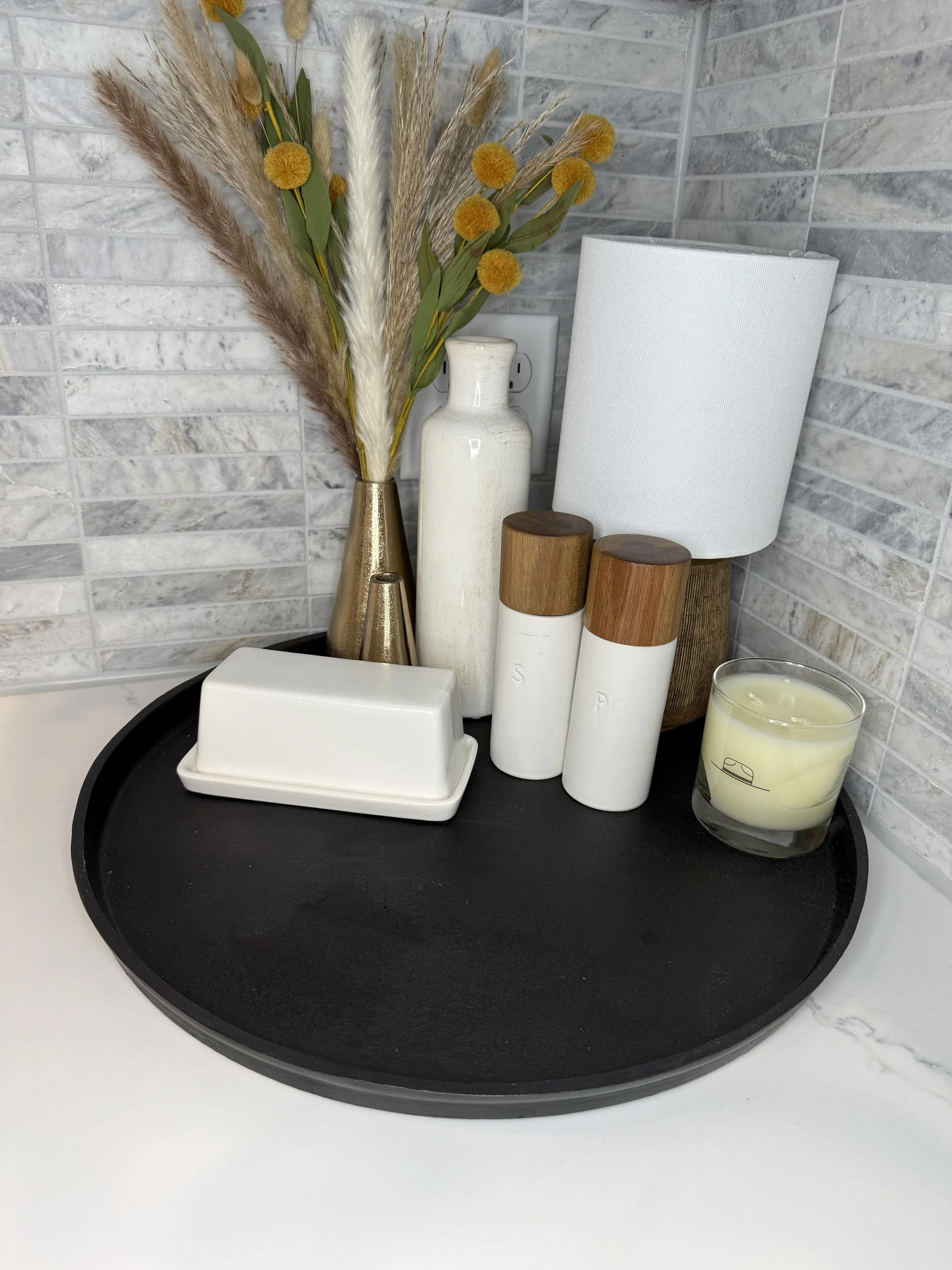 This ranch-style home at Legacy Villa in Watertown, SD features a white brick exterior, dark chimney, and spacious garage—perfectly set for a peaceful, upscale luxury stay.