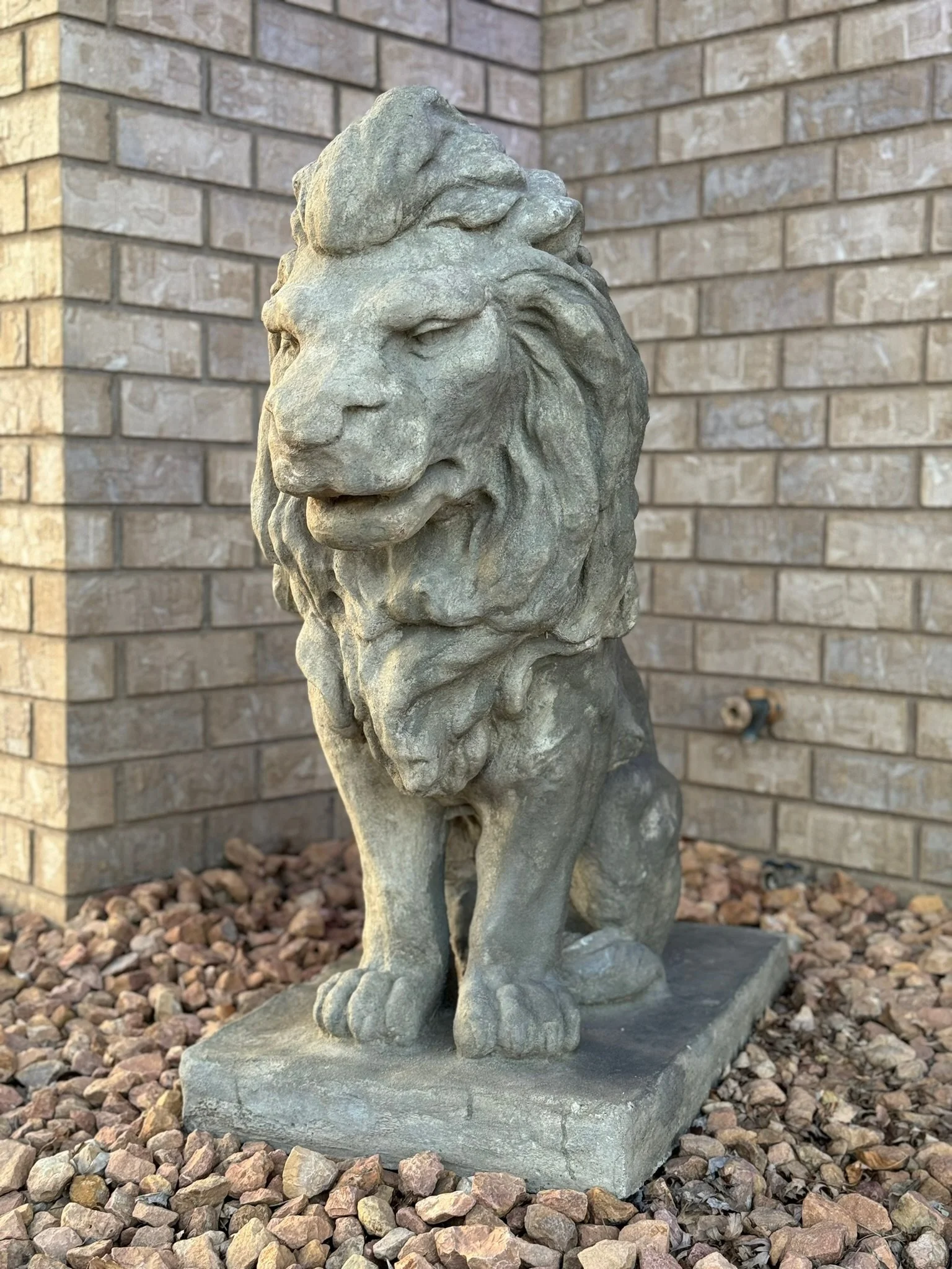A regal stone lion statue greets guests at Legacy Villa in Watertown, SD, adding classic charm to the setting of your unforgettable luxury stay.