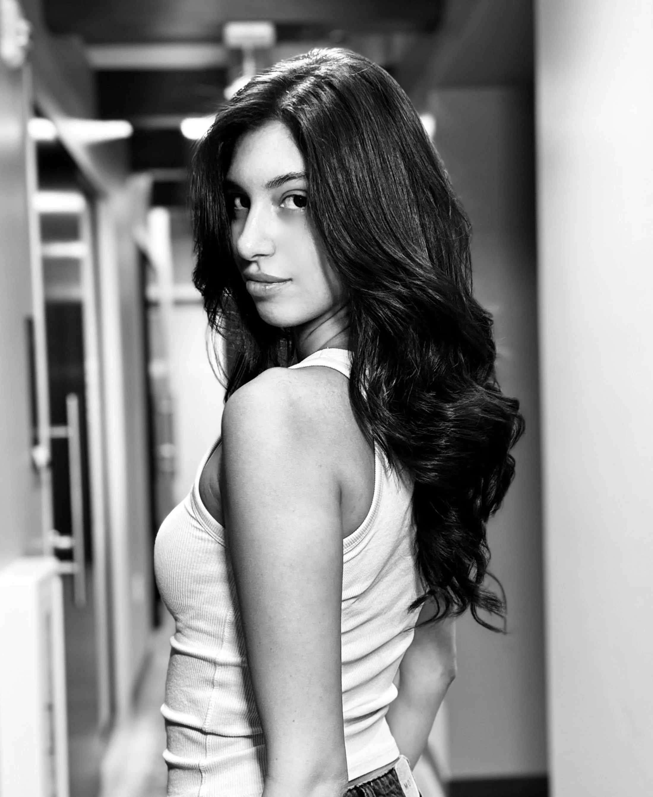 A black and white photo of two women close together, both with long, shiny hair. Styled by PABLO THE STYLIST