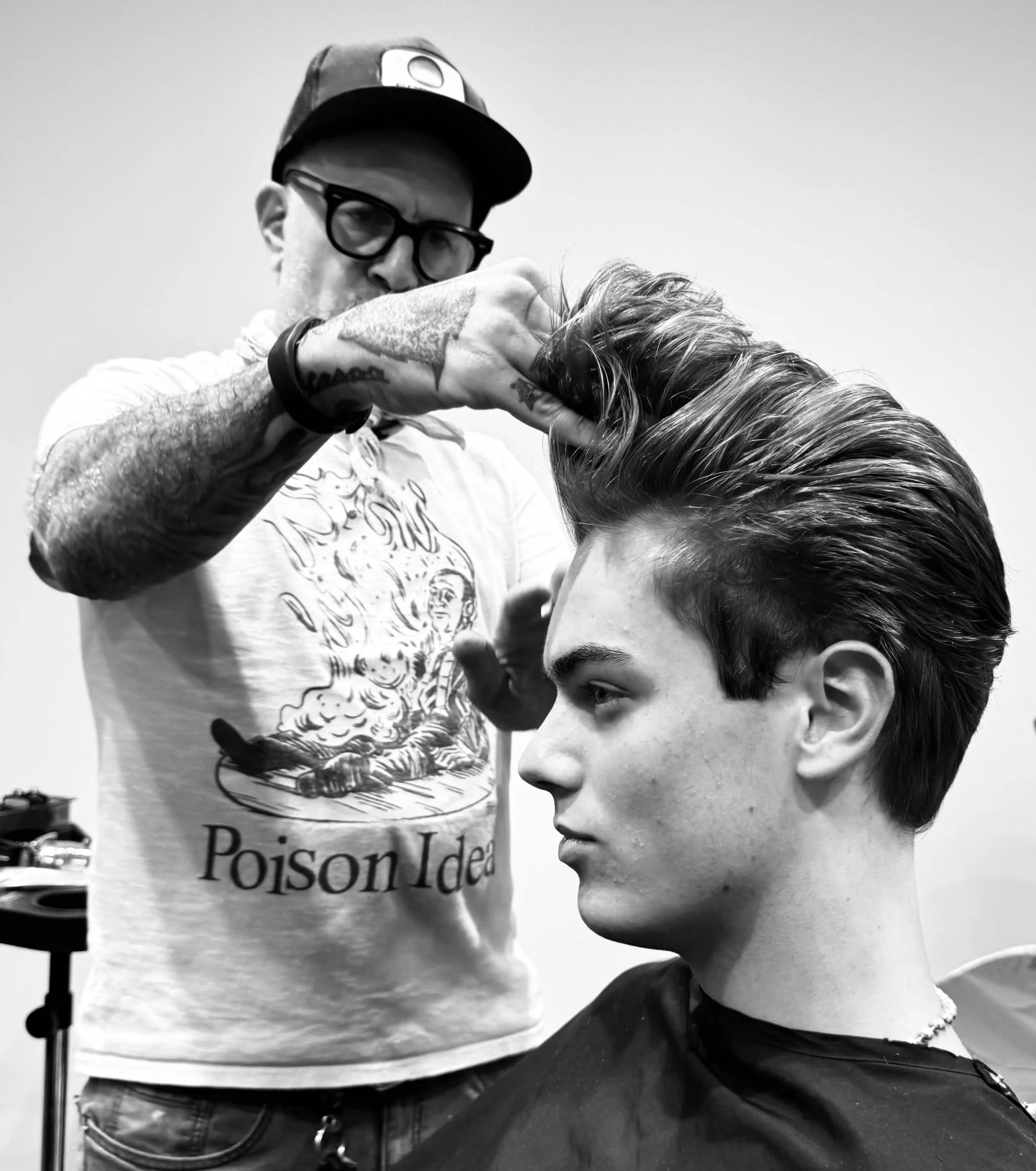 A person having their hair cut or styled at a salon, with a barber's hand adjusting or styling the hair. Styled by Blonde model hair Styled by PABLO THE STYLIST