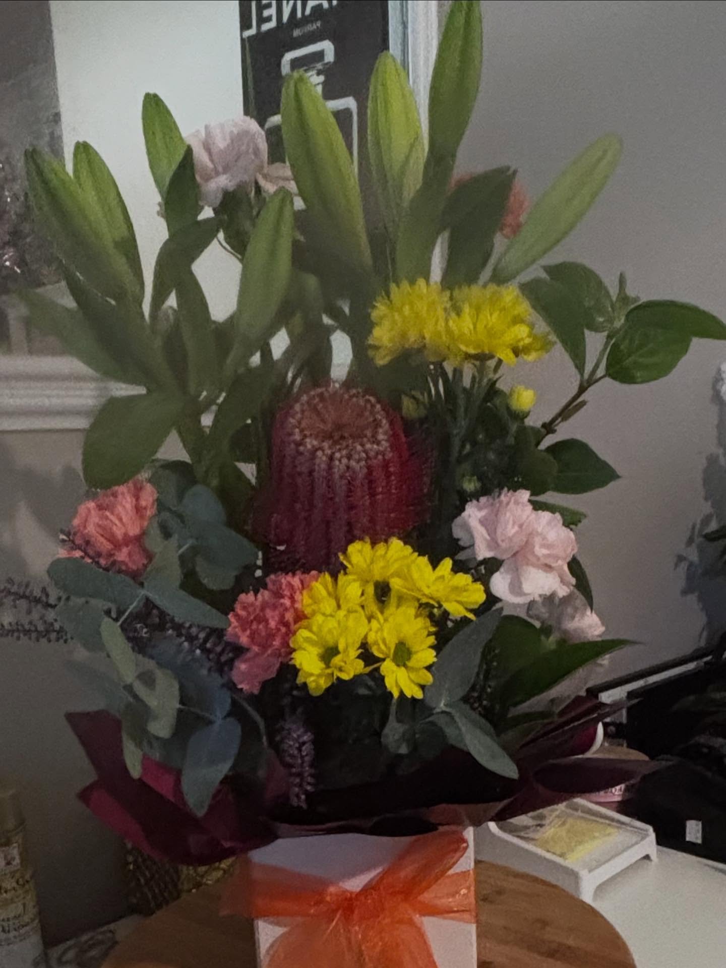✨ A little burst of sunshine in a box ✨
Bright, cheerful blooms designed to lift anyone&rsquo;s day &mdash; featuring lilies, chrysanthemums, carnations, and a striking banksia as the centrepiece. Perfect for birthdays, thank-yous, or just because 💛
