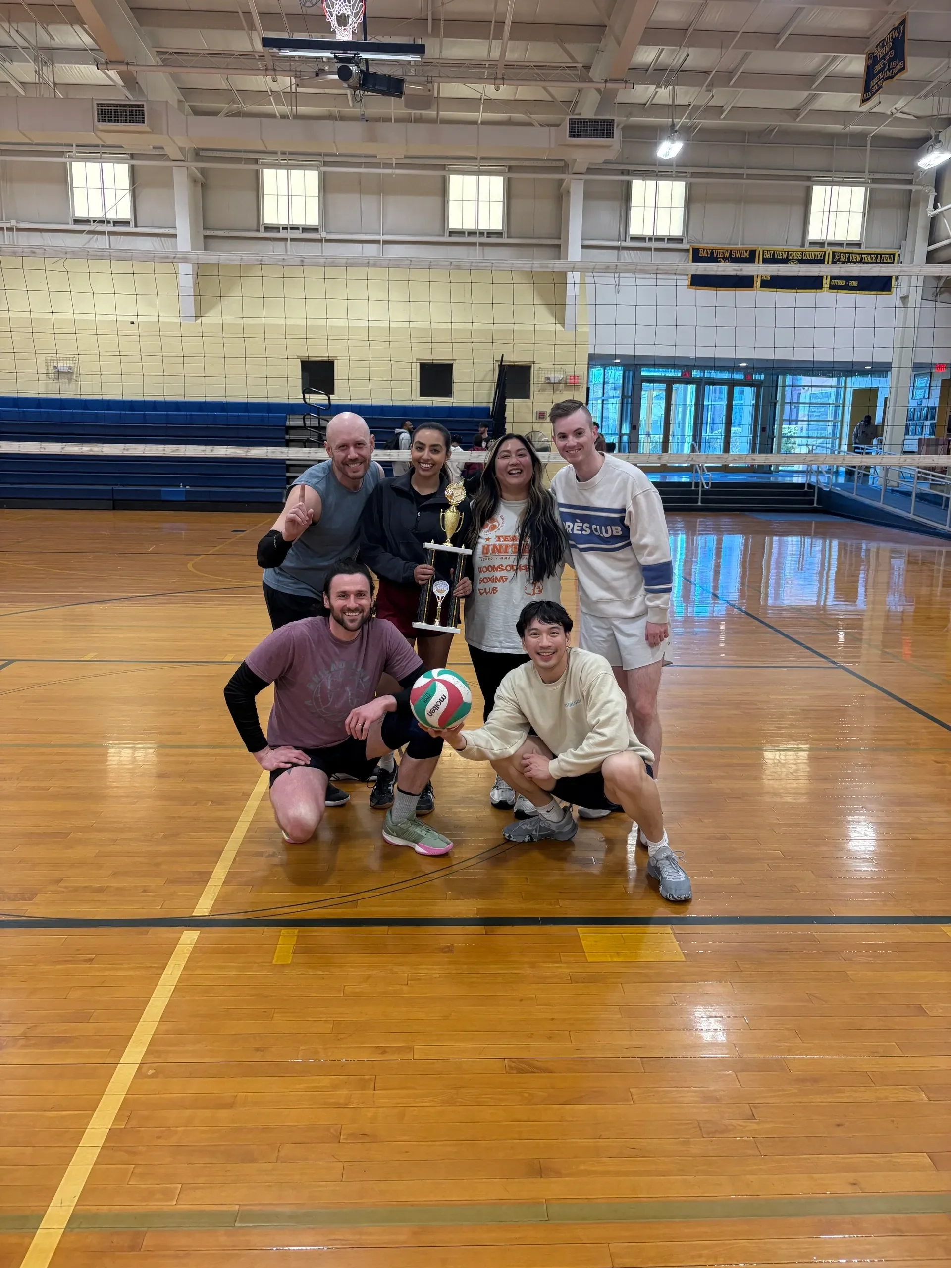 Volleyball Players holding trophy, celebration