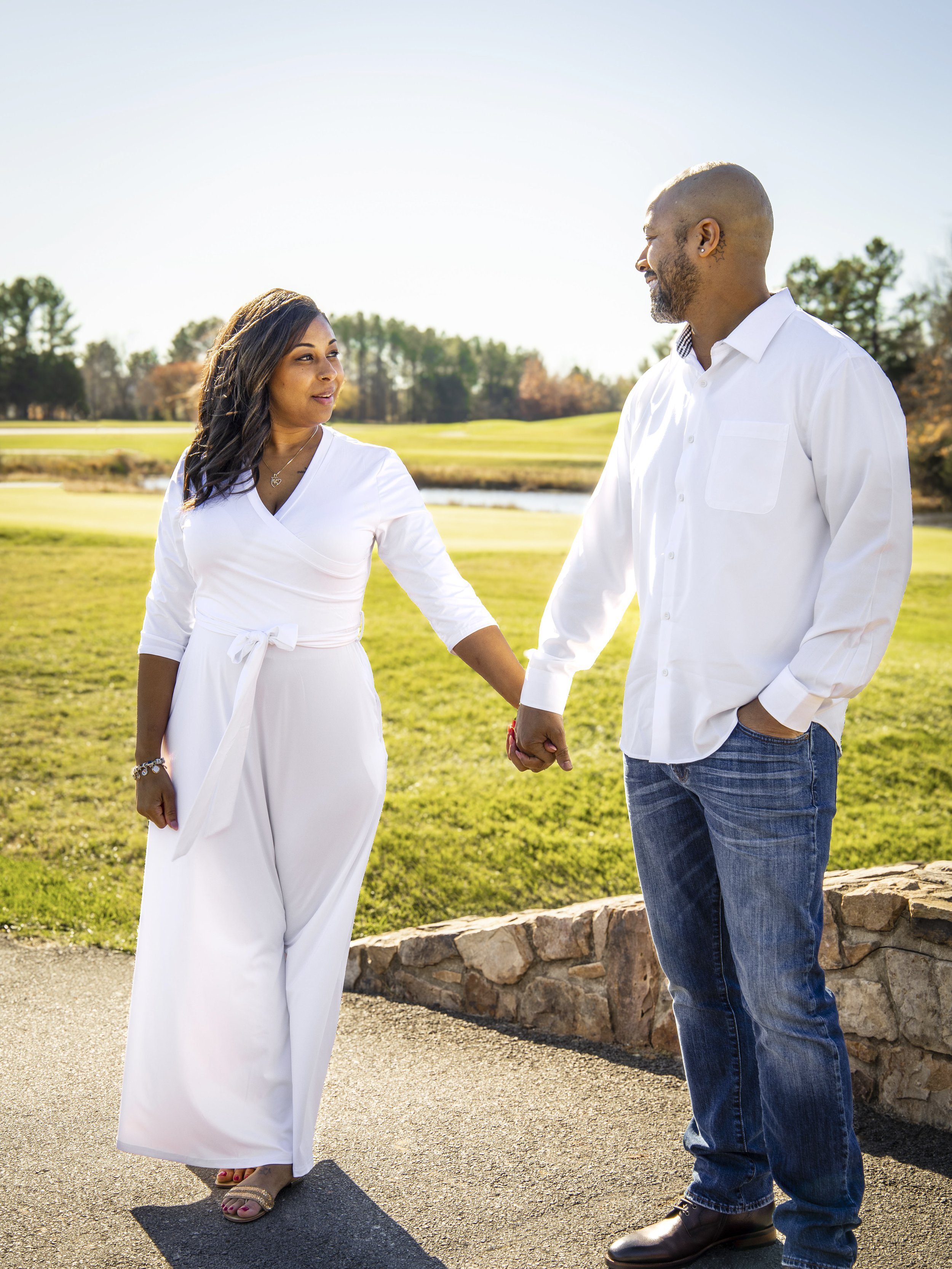Maryland portrait photographer captures couple holding hands outdoors in casual attire.