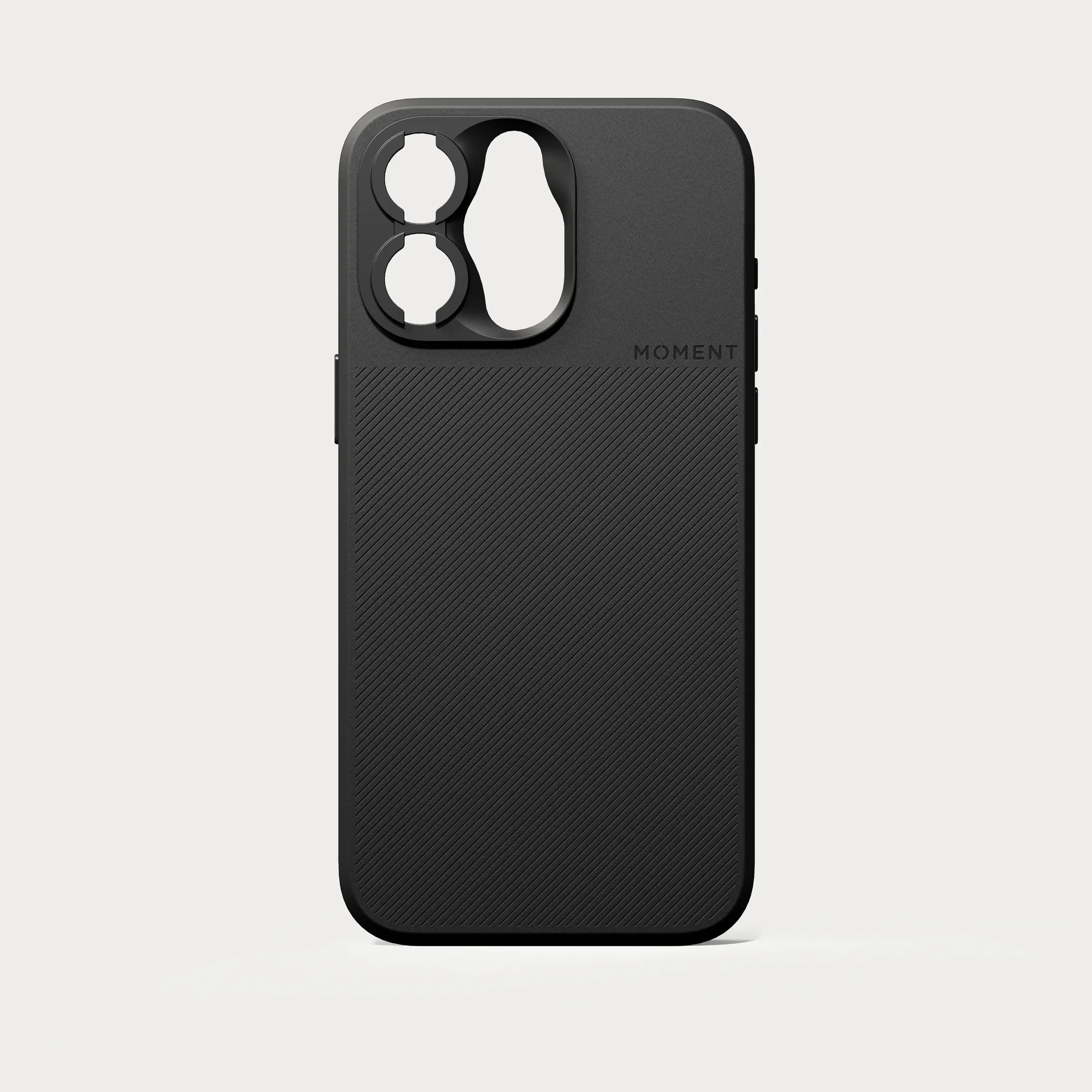 A black modular camera accessory case with cutouts for lenses or filters, and the brand name 'MOMENT' embossed on the lower part.
