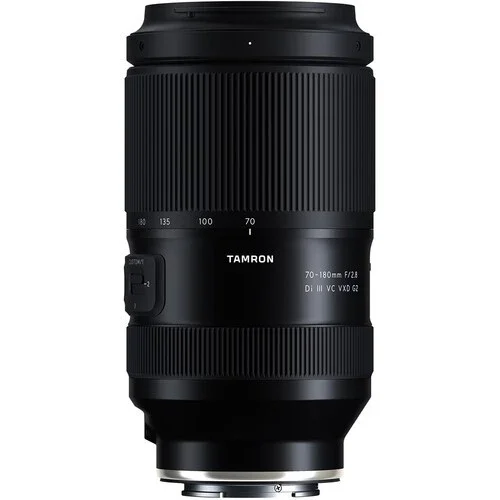 A black Tamron camera lens with zoom and focus rings, marked with 70-180mm and f/2.8 aperture, on a white background.