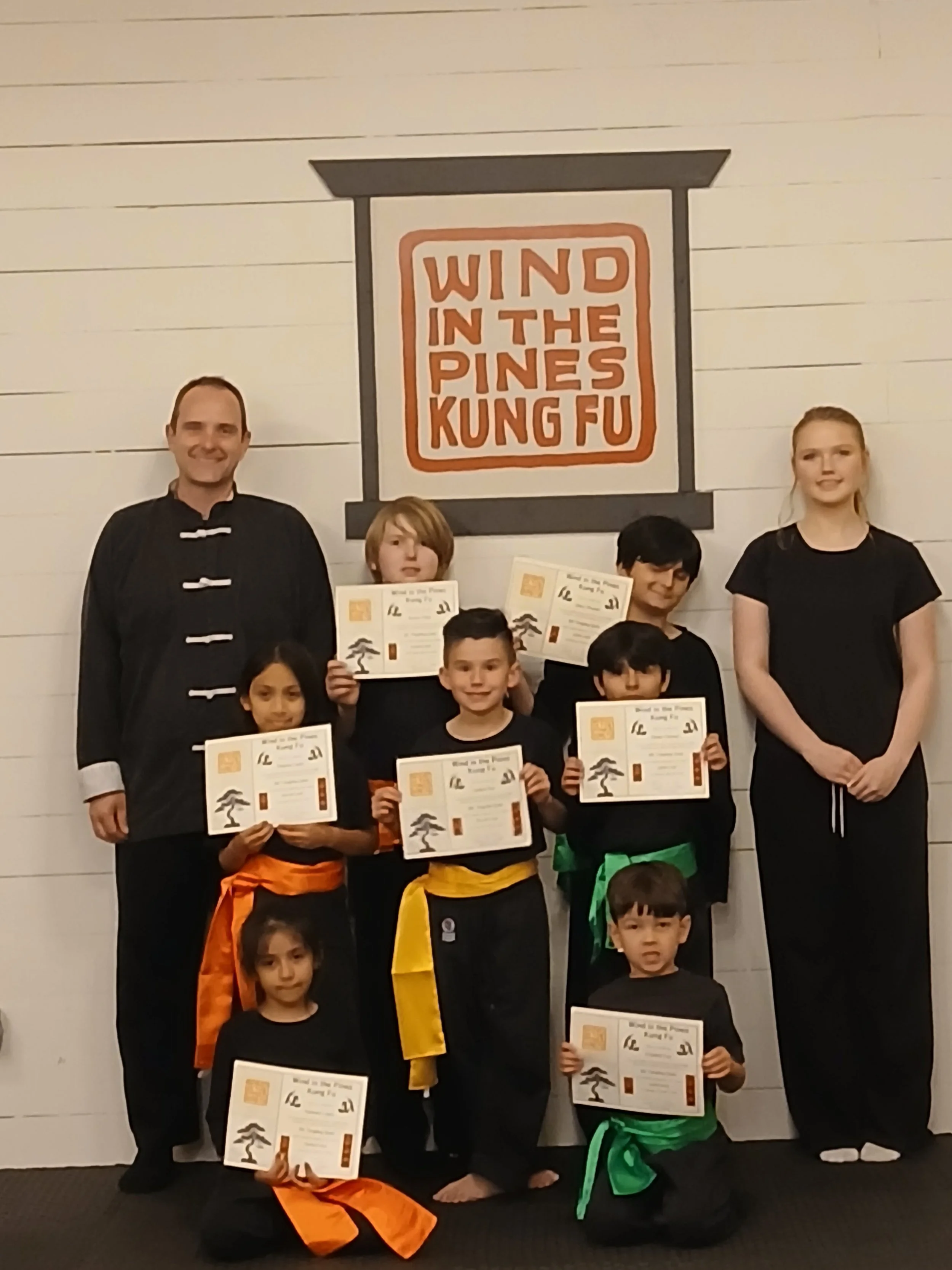Happy students in the Lufkin youth Kung Fu program showing confidence and teamwork after a training session.