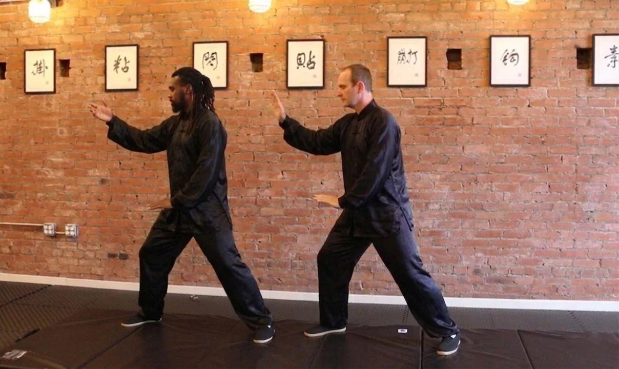Professional instructors leading a Tai Chi and meditation session for stress management and joint health at our Lufkin studio.