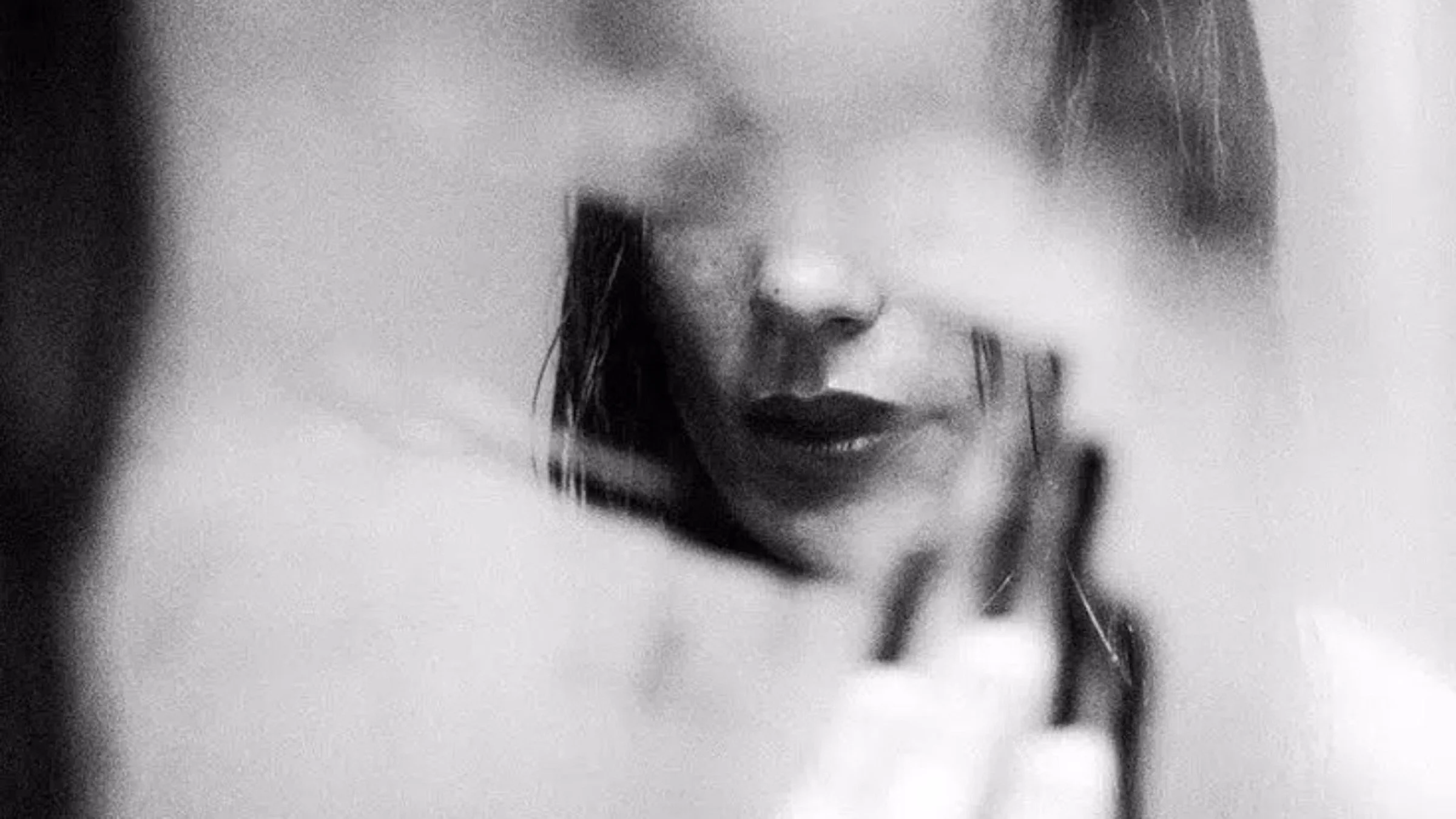 an image of a woman before a broken mirror