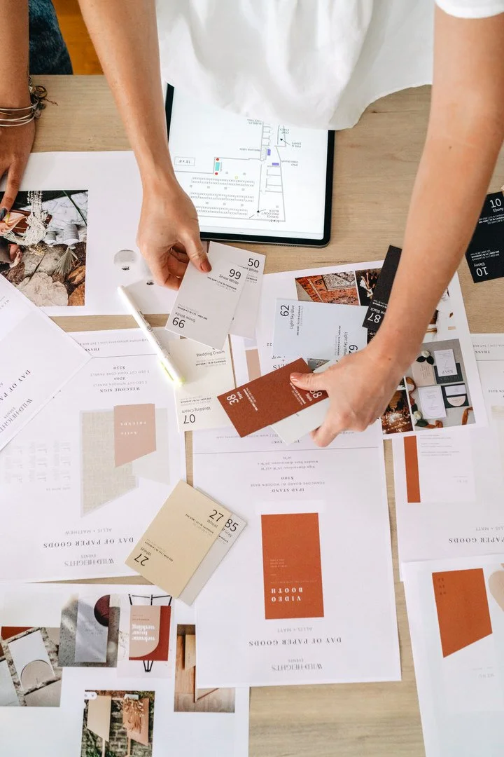 A brand shoot in San Diego. A black ceramic vase with a textured horizontal ridged pattern, placed on a light-colored surface against a neutral beige background.