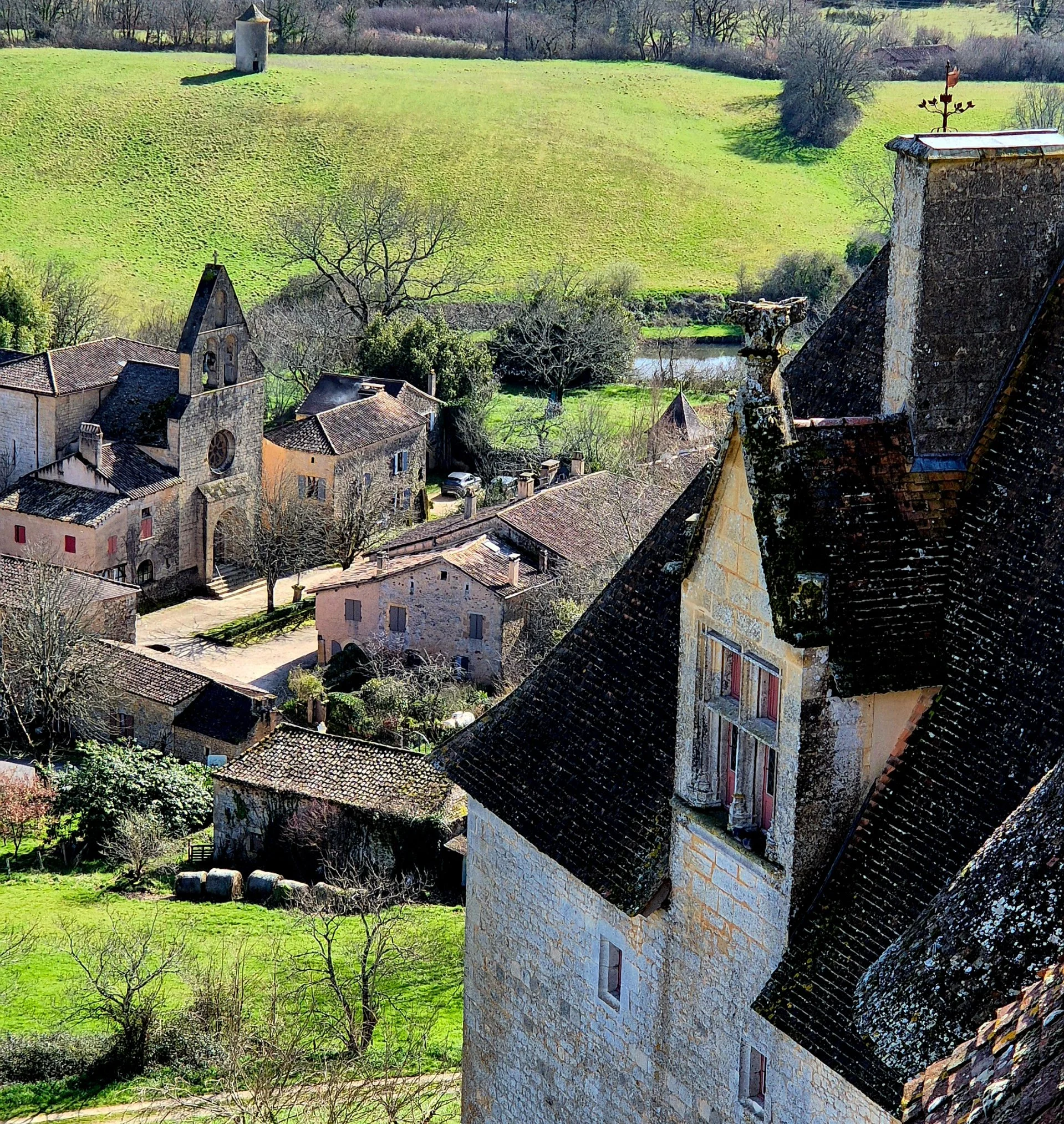 Château de Biron towering above Biron medieval village with a view of the village and church