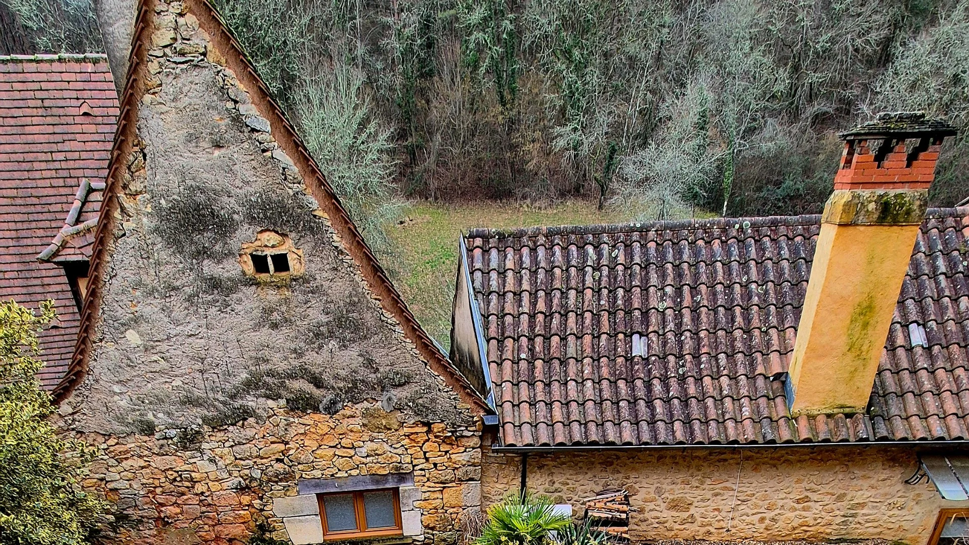 super picture of an old stone house with a pointed roof