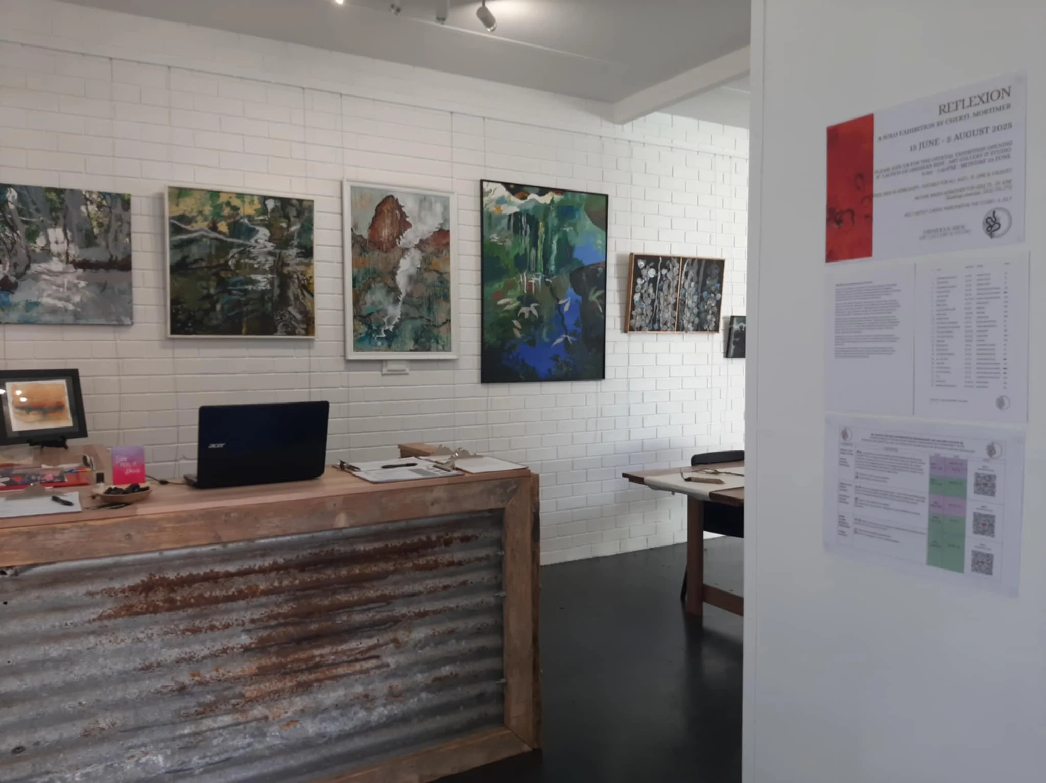 A hand holding a glass orb reflecting a sunset over the ocean with a beach in the background.