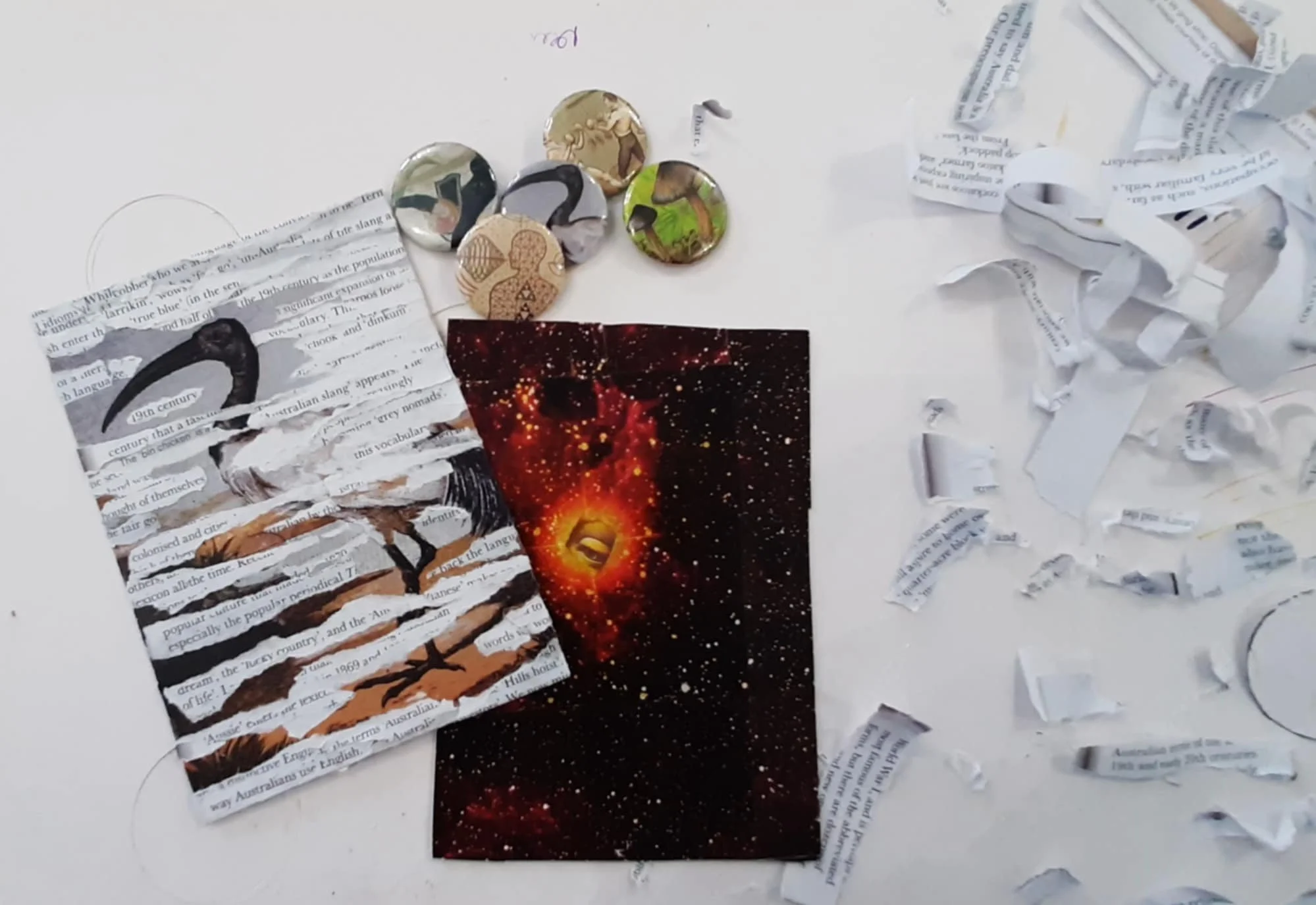 Modern wooden building with large glass window situated in a mountainous landscape, surrounded by green shrubbery and grass, under an overcast sky.