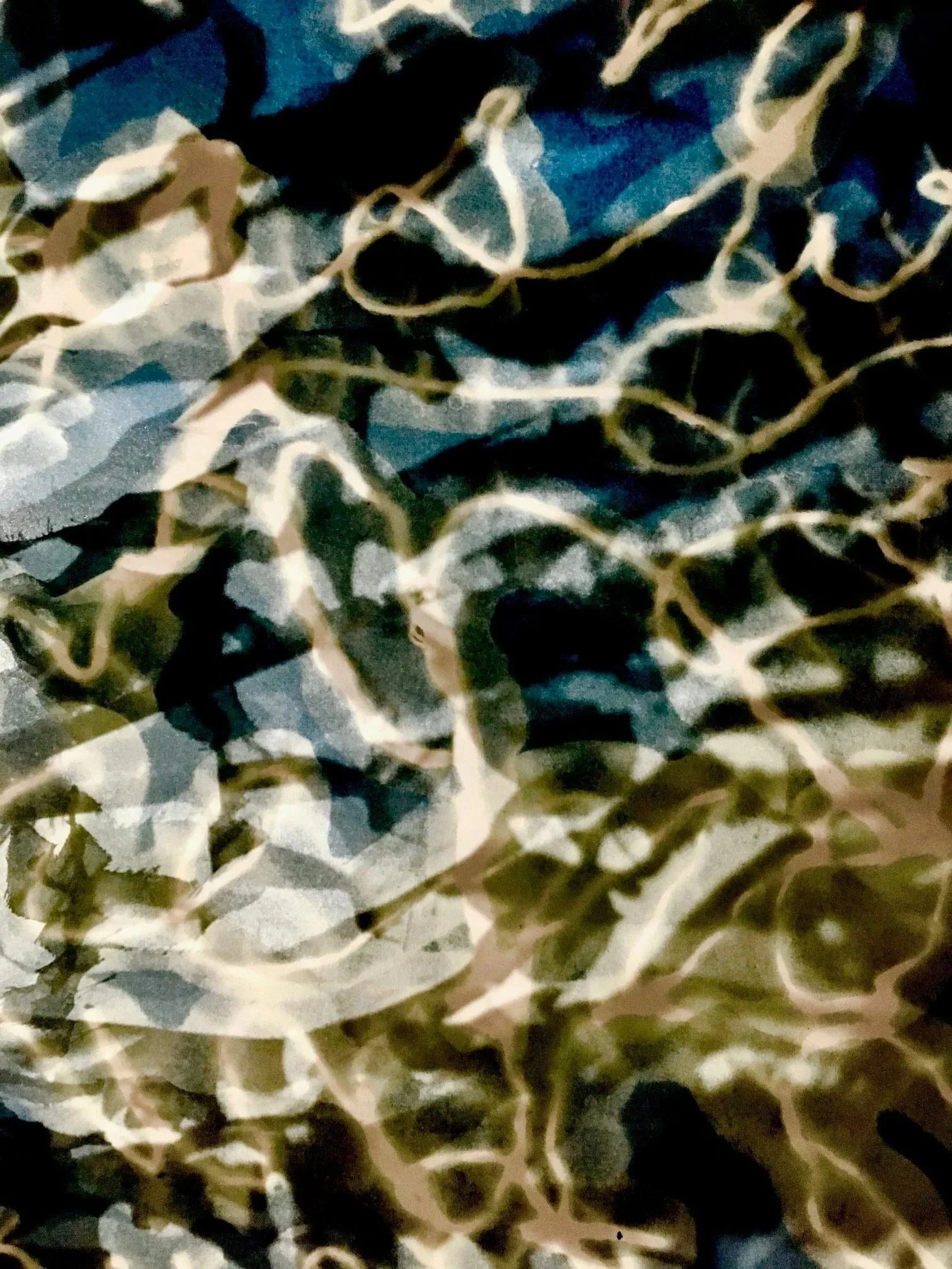 A close-up of crumpled fabric with a camouflage pattern in shades of green, brown, black, and gray.
