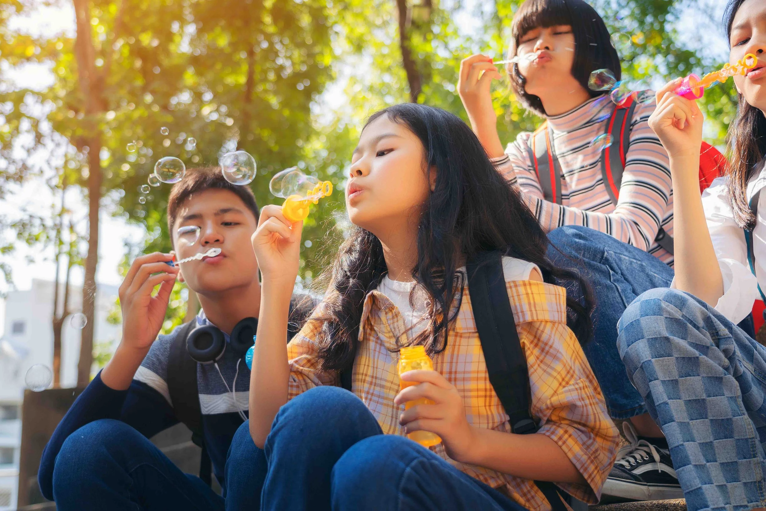 Sunnyside children blowing bubbles outdoors