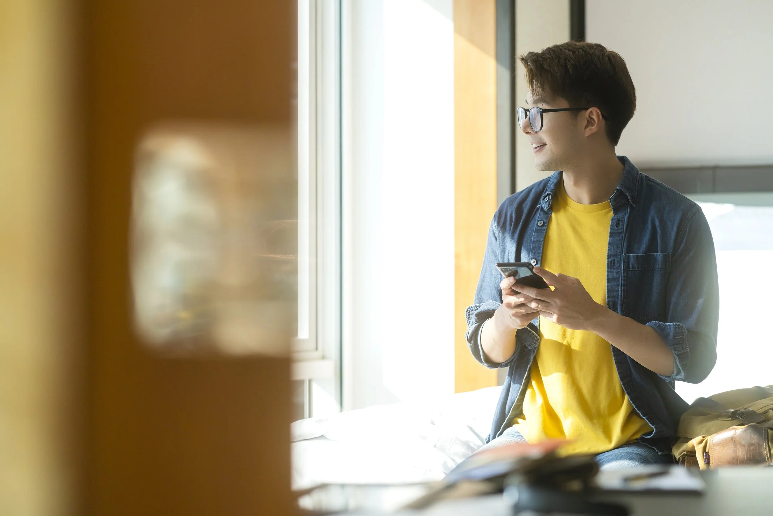 Calm teen using a device with Sunnyside Circle