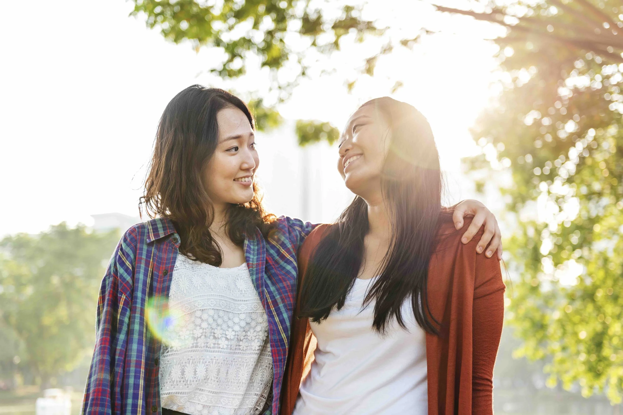 Sunnyside Social Life System™ illustration of two women smiling and hugging outdoors