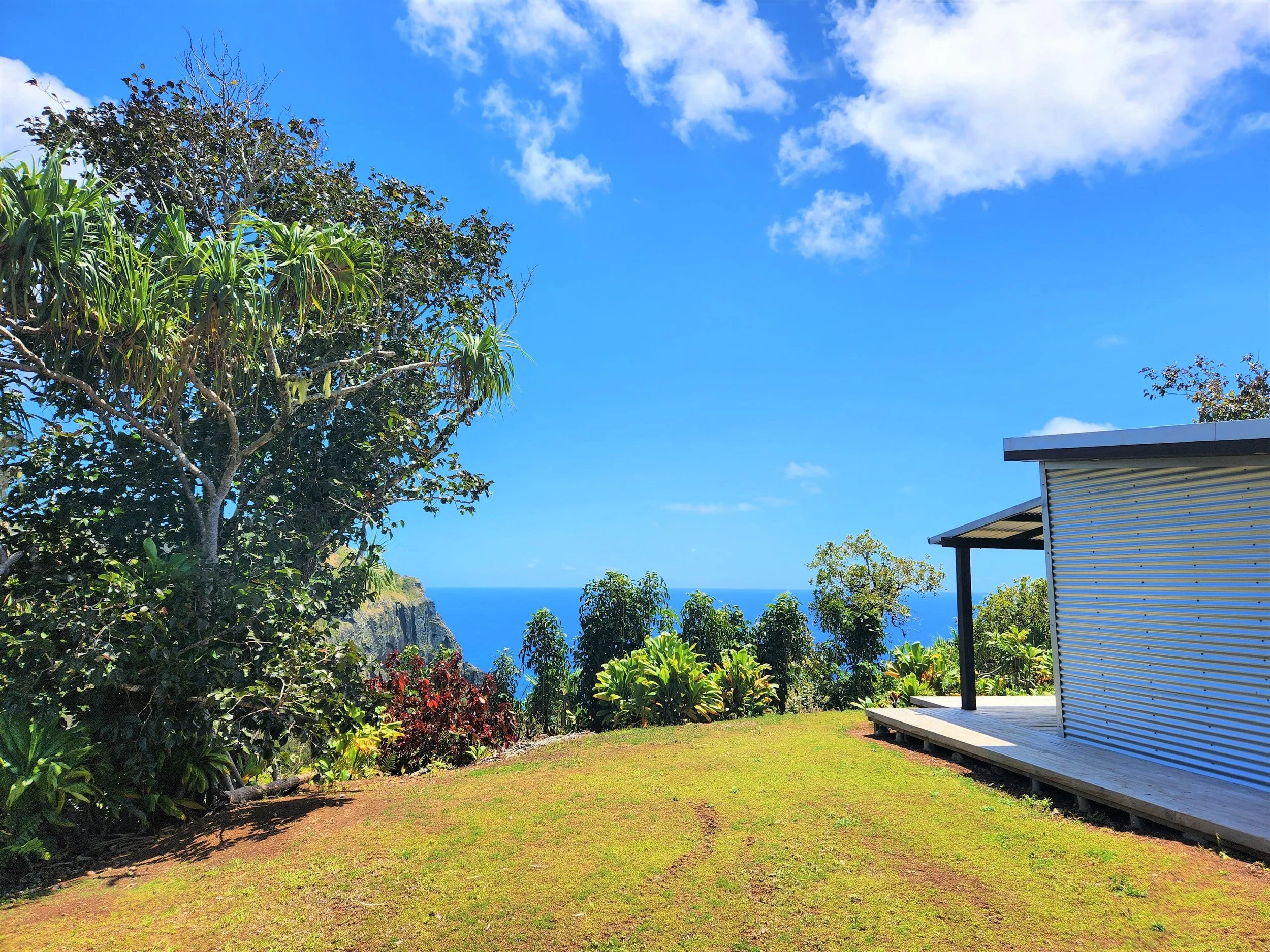 Scenic view with a building, trees, and ocean