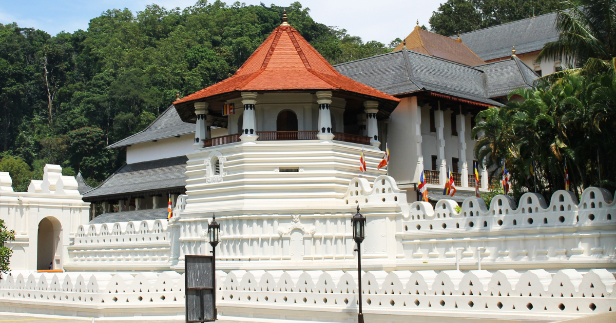 White exterior walls and tiered roof of the Temple of the Sacred Tooth Relic in Kandy