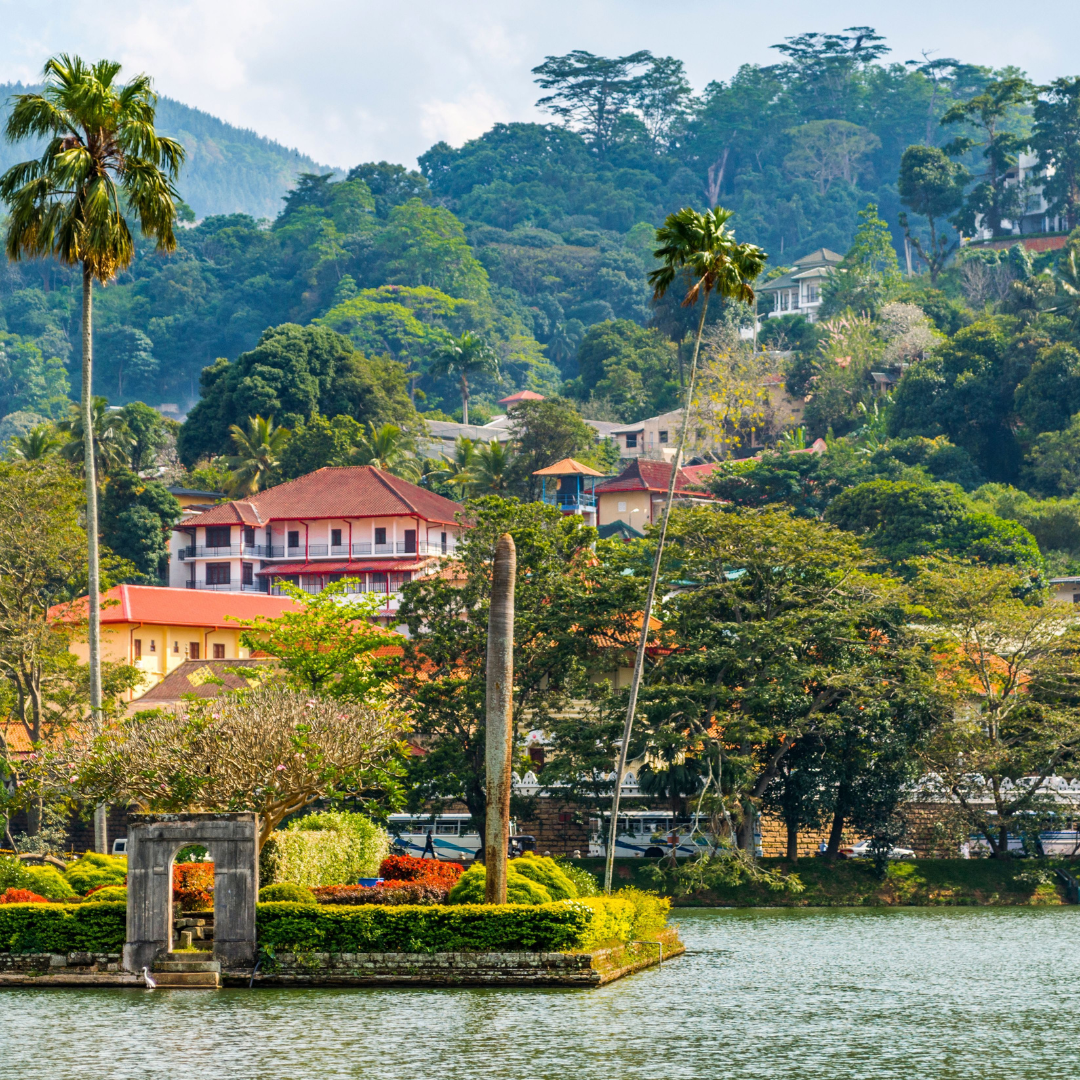 View across Kandy Lake towards the green hills and historic buildings of Kandy in Sri Lanka’s Central Province.