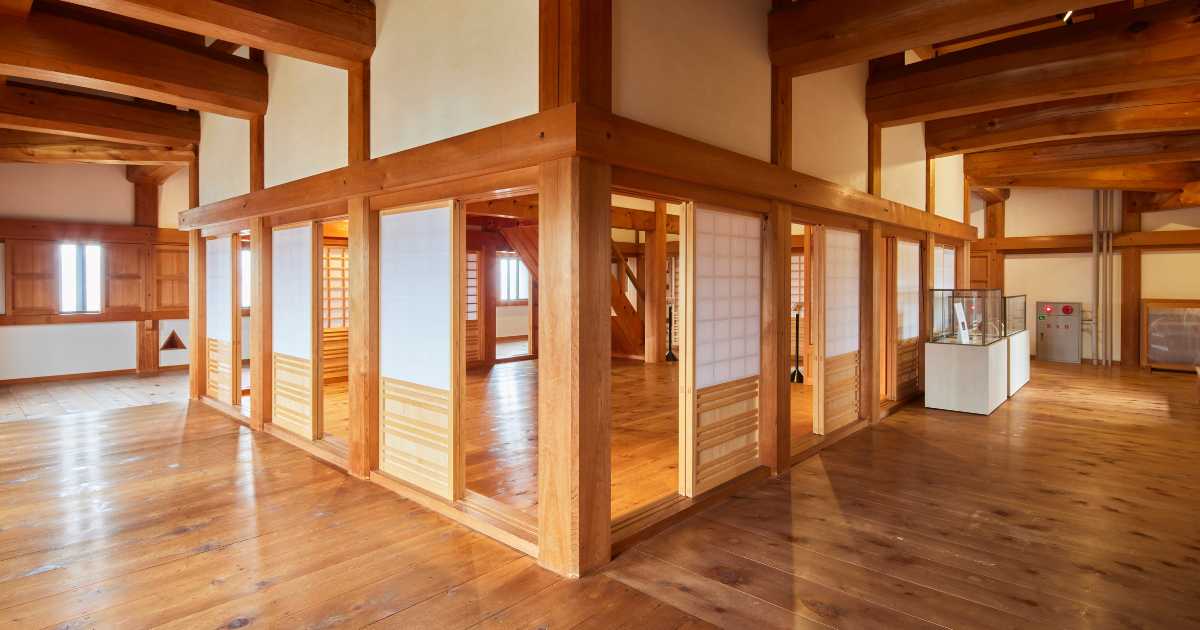Timber interior of Ozu Castle showing traditional wooden joinery and polished floors.