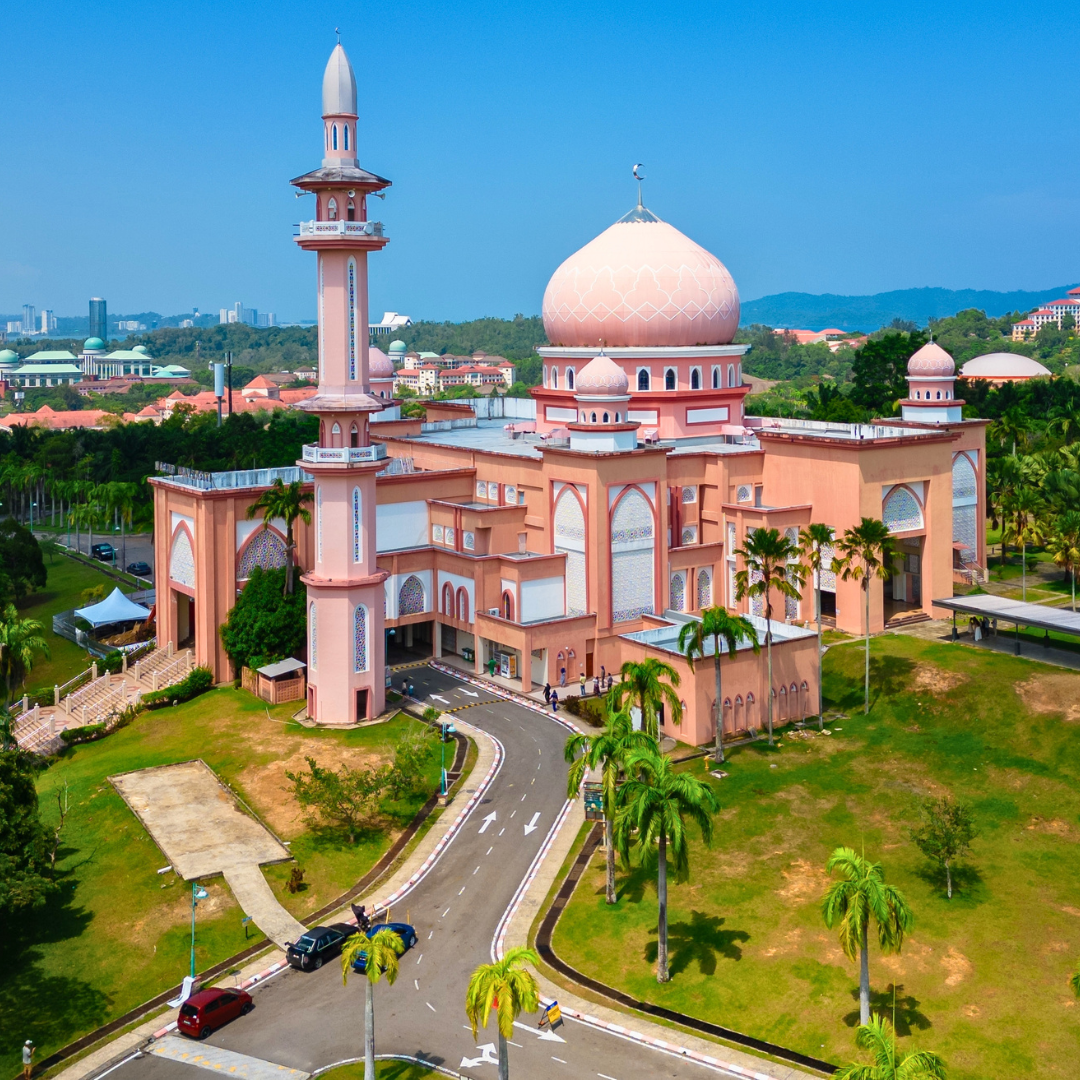 Aerial view of the pink-domed Kuching City Mosque overlooking the city skyline in Sarawak, Malaysian Borneo.