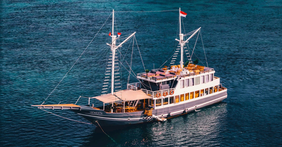 The Semesta luxury phinisi liveaboard sailing through the waters of Komodo National Park, Indonesia, offering an unforgettable cruising experience as part of our Indonesia small group tour.