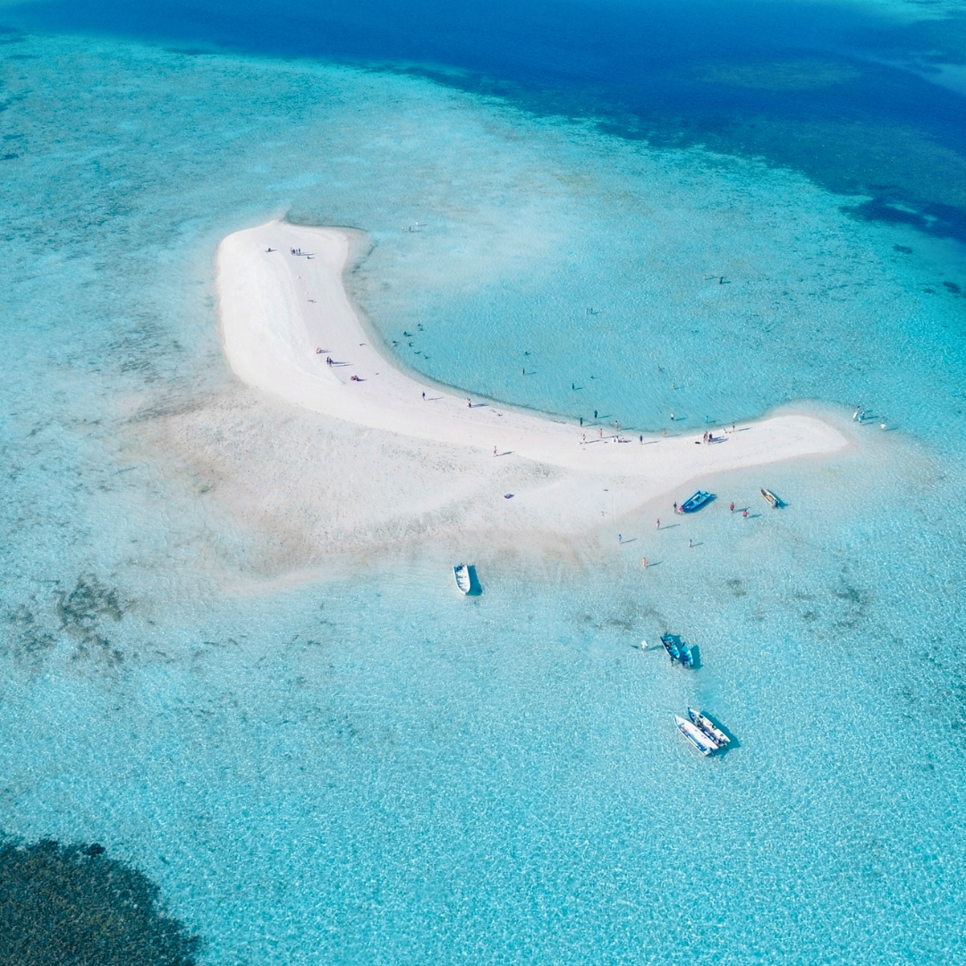A pristine white sandbank surrounded by turquoise waters in Komodo National Park, one of the spectacular island landscapes visited on our Indonesia tour.