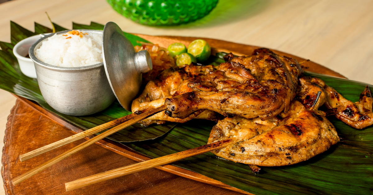 Chicken inasal served with rice and calamansi on a banana leaf in the Visayas.