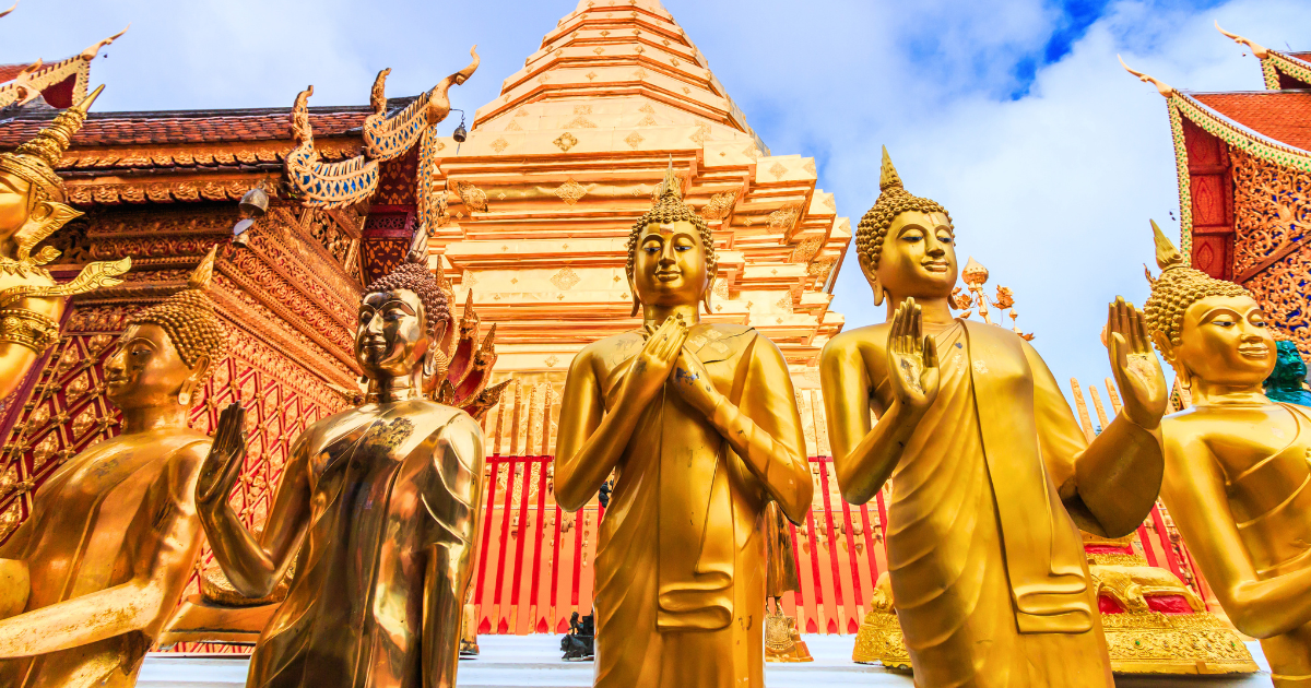 Standing golden Buddha images in front of the chedi at Wat Phra That Doi Suthep in Chiang Mai