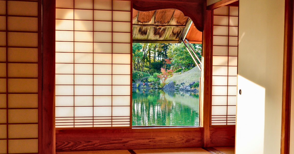 Traditional ryokan tatami room with shoji screens and garden view in Japan