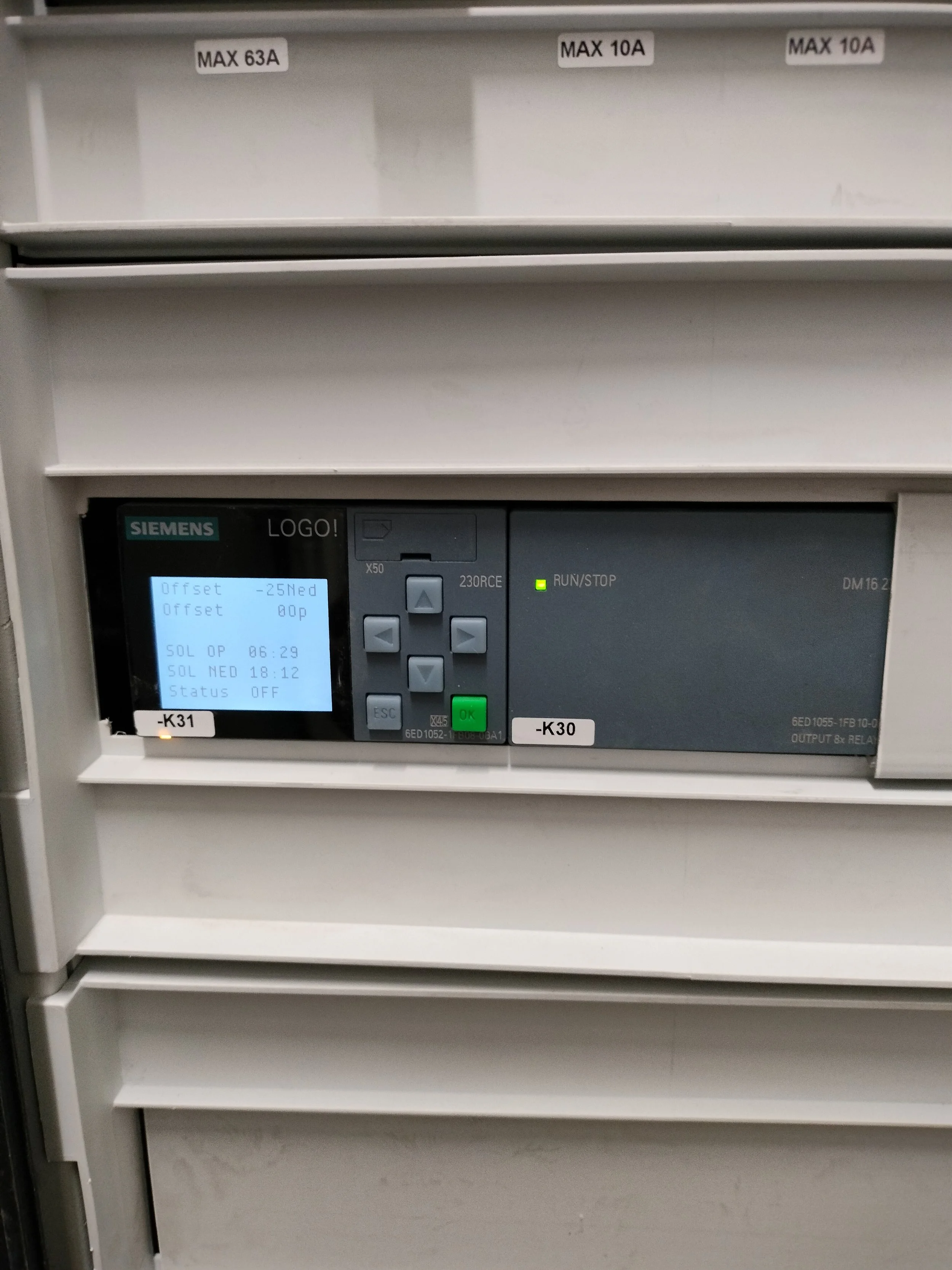 Elektrokontrollenehed fra Siemens med skærm, knapper og statuslys, placeret i et metalskab med mærker labeling K31 og K30.