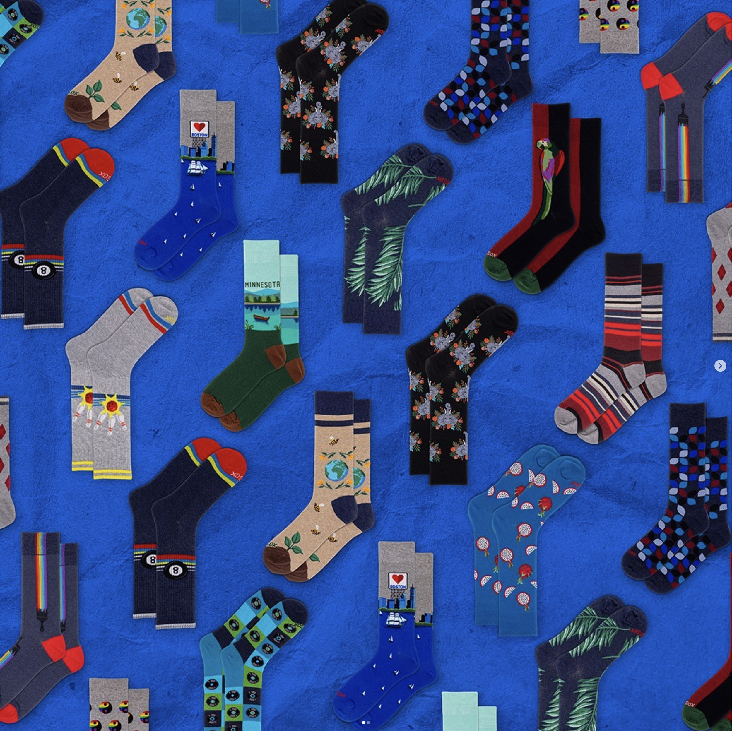 Assorted colorful socks with various patterns on a blue background