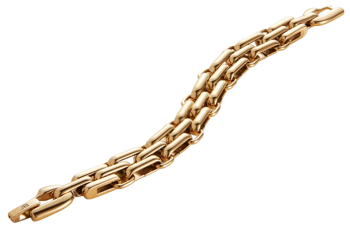 A gold chain necklace with elongated links on a black and white stepped surface.