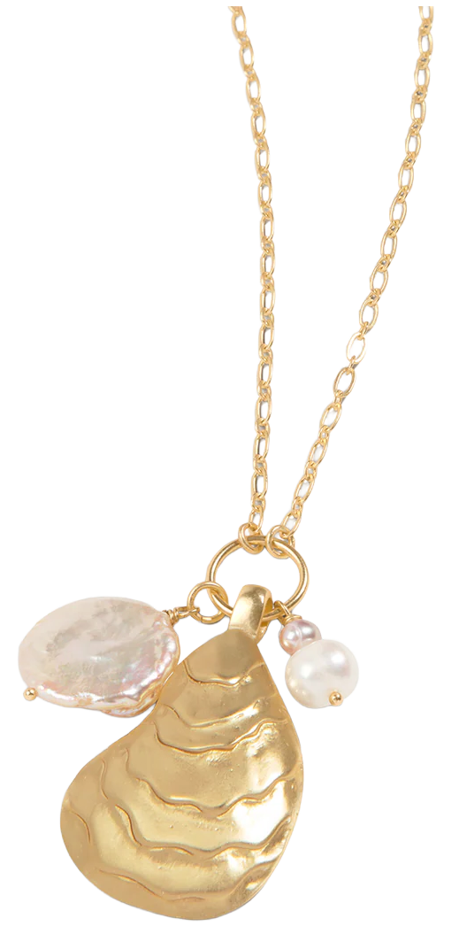 Gold necklace with three charms: a large gold shell-shaped pendant, a small white pearl, and a round white pearl, against a black background.