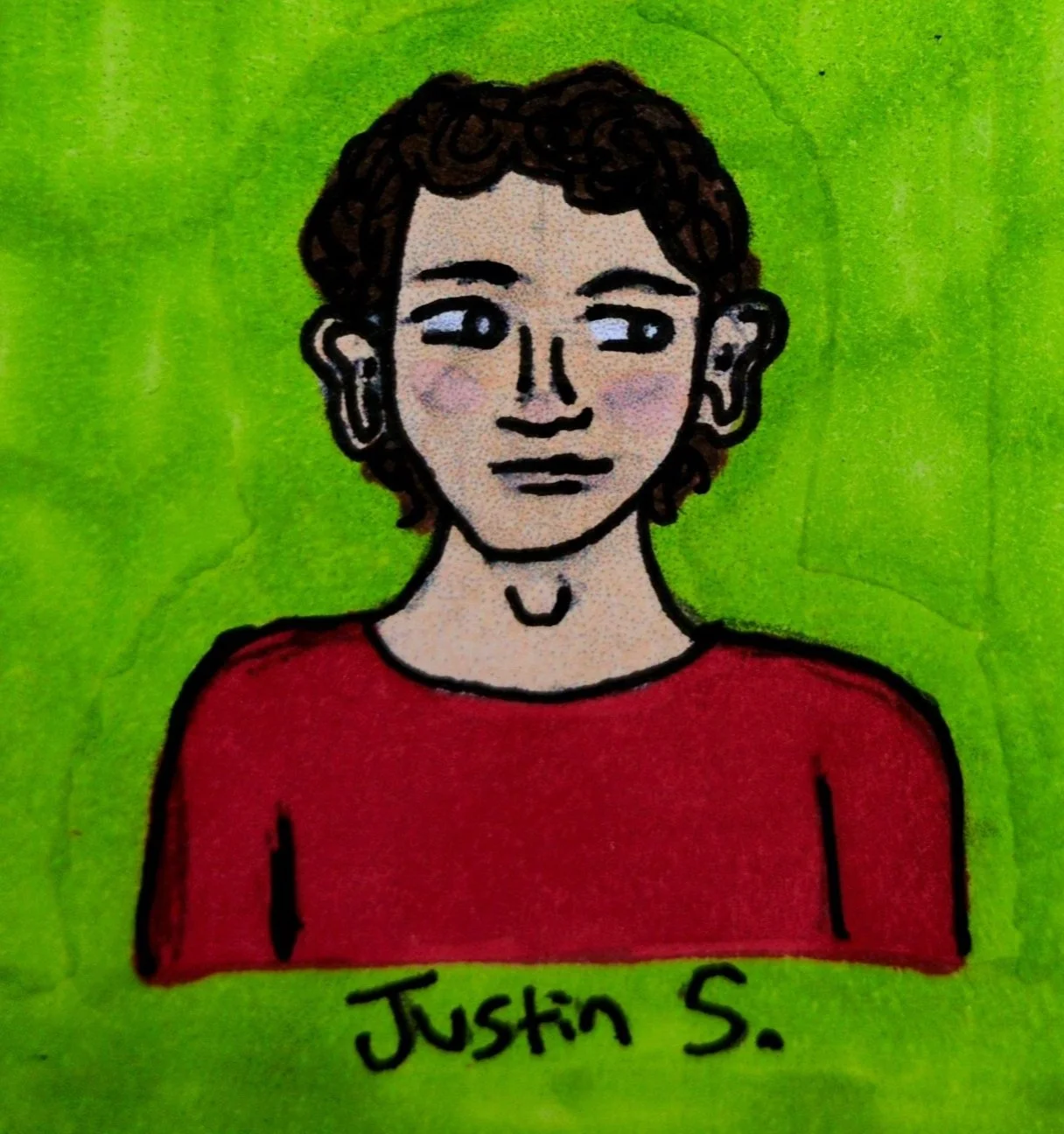 boy with brown, curly hair wearing a red T shirt