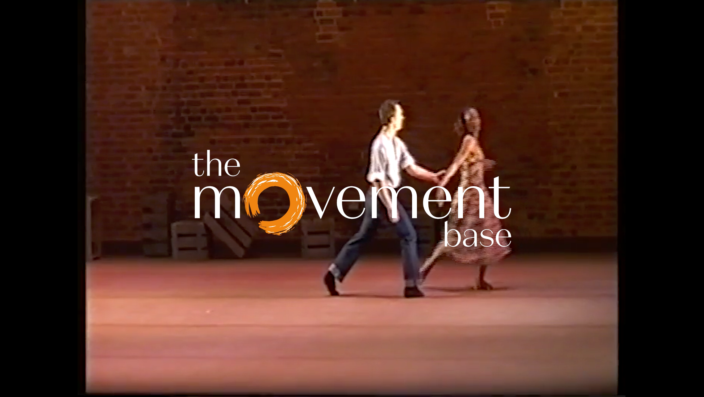 Still from the historic part of the film, of TMB founders Sam and Glen, dancing on stage in the 90s.