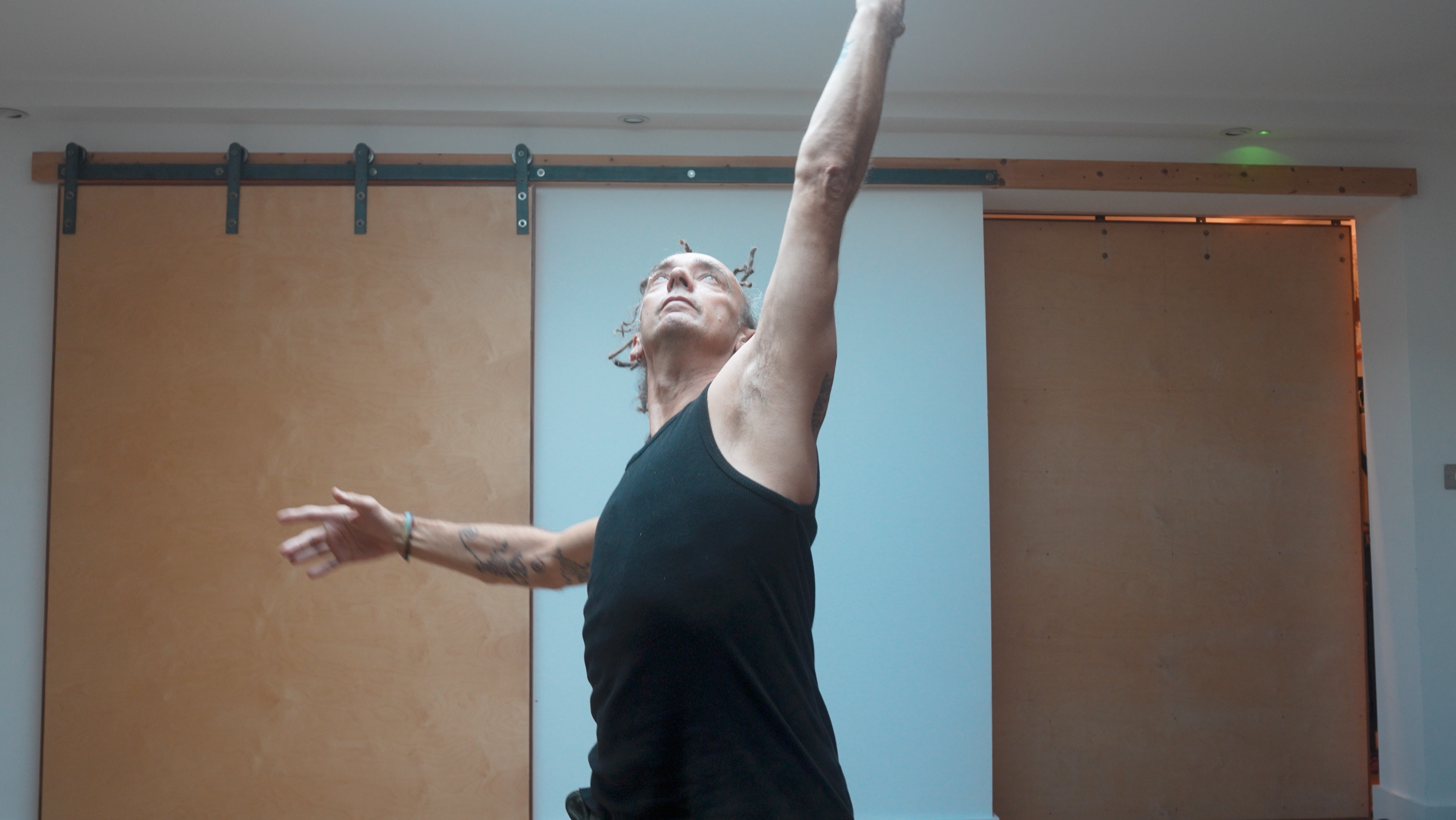 Still from the modern segment of the film, of TMB founder Glen performing a dance routine.