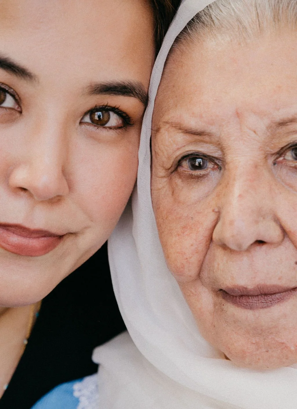 Two women from different generations photographed closely together, reflecting heritage, family, and continuity.