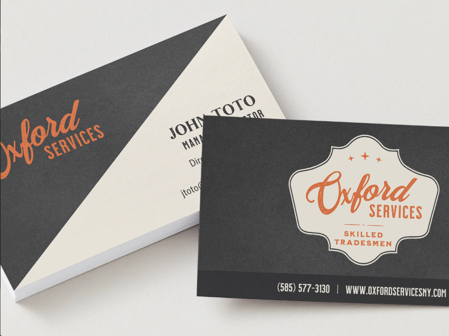 Business cards for Oxford Services, featuring a logo with 'Skilled Tradesmen' and contact details.
