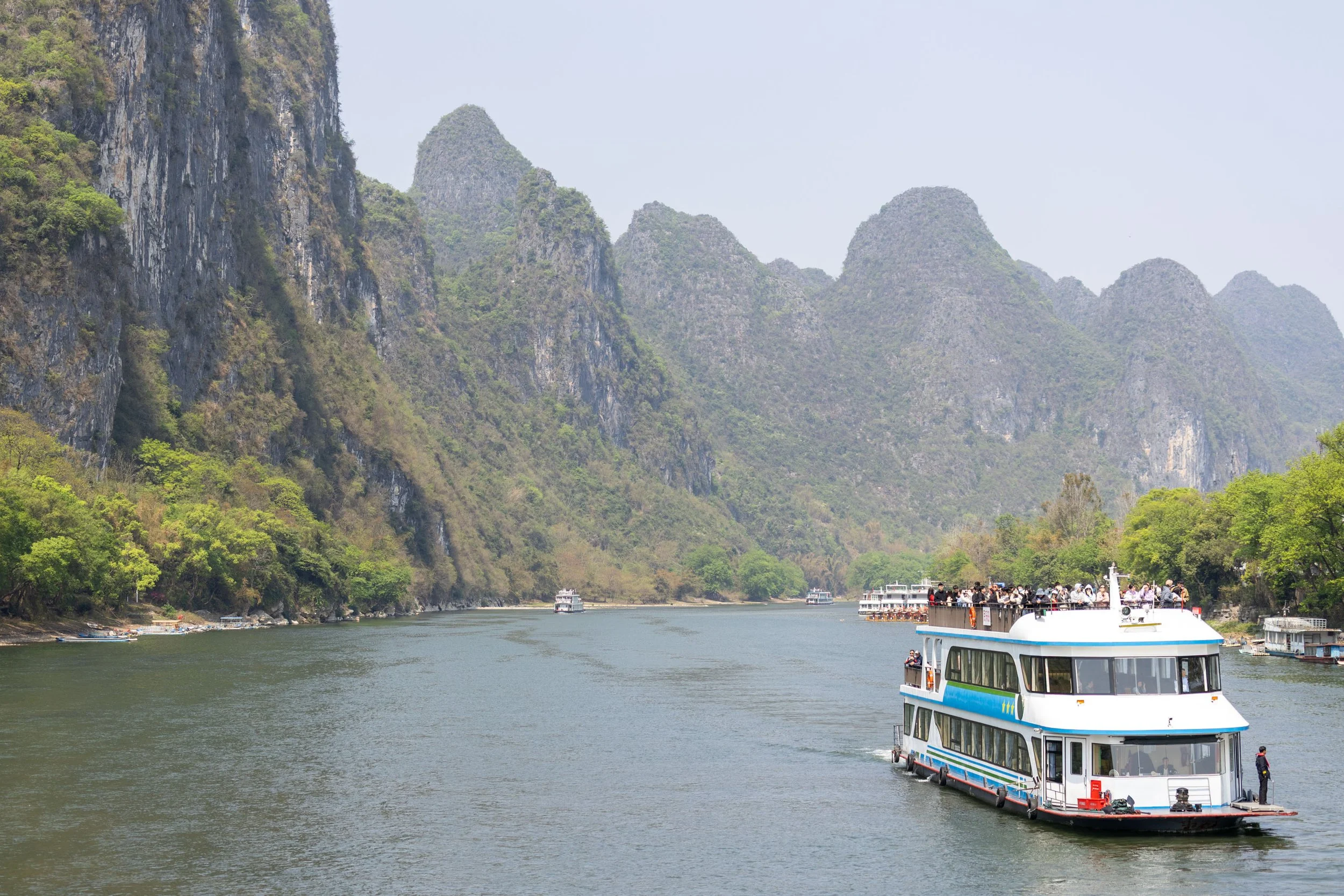 Scenic river with cruise boat and karst mountains