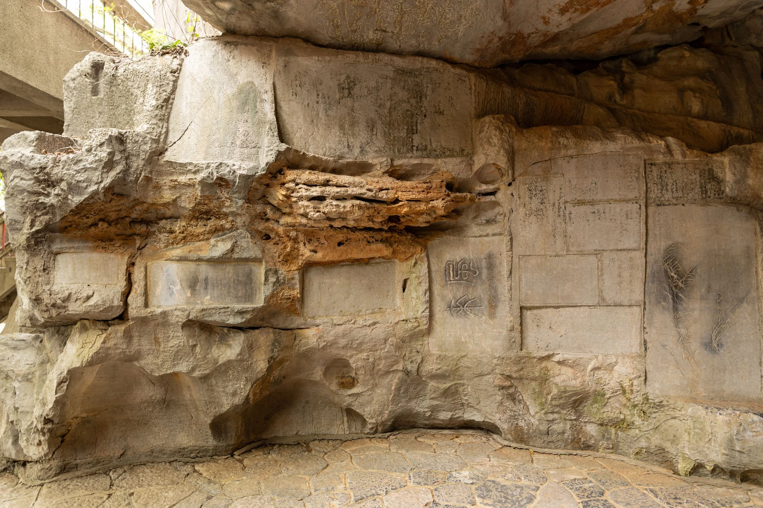 Stone wall with engraved carvings and etched designs