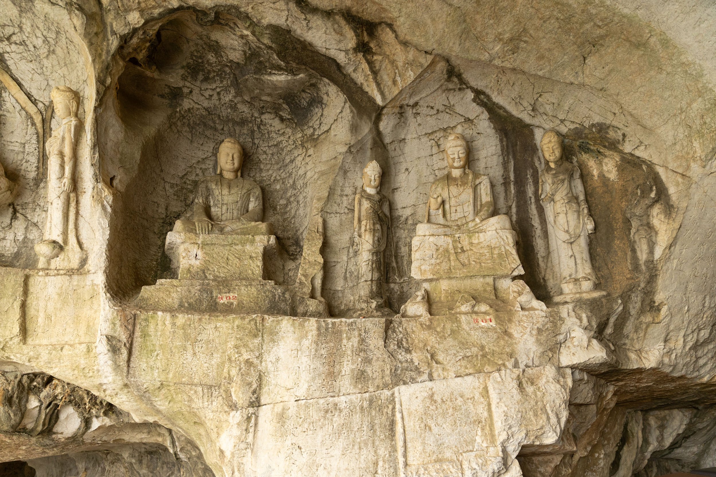 Ancient stone carvings of Buddhist figures in a cave in Guilin, China.